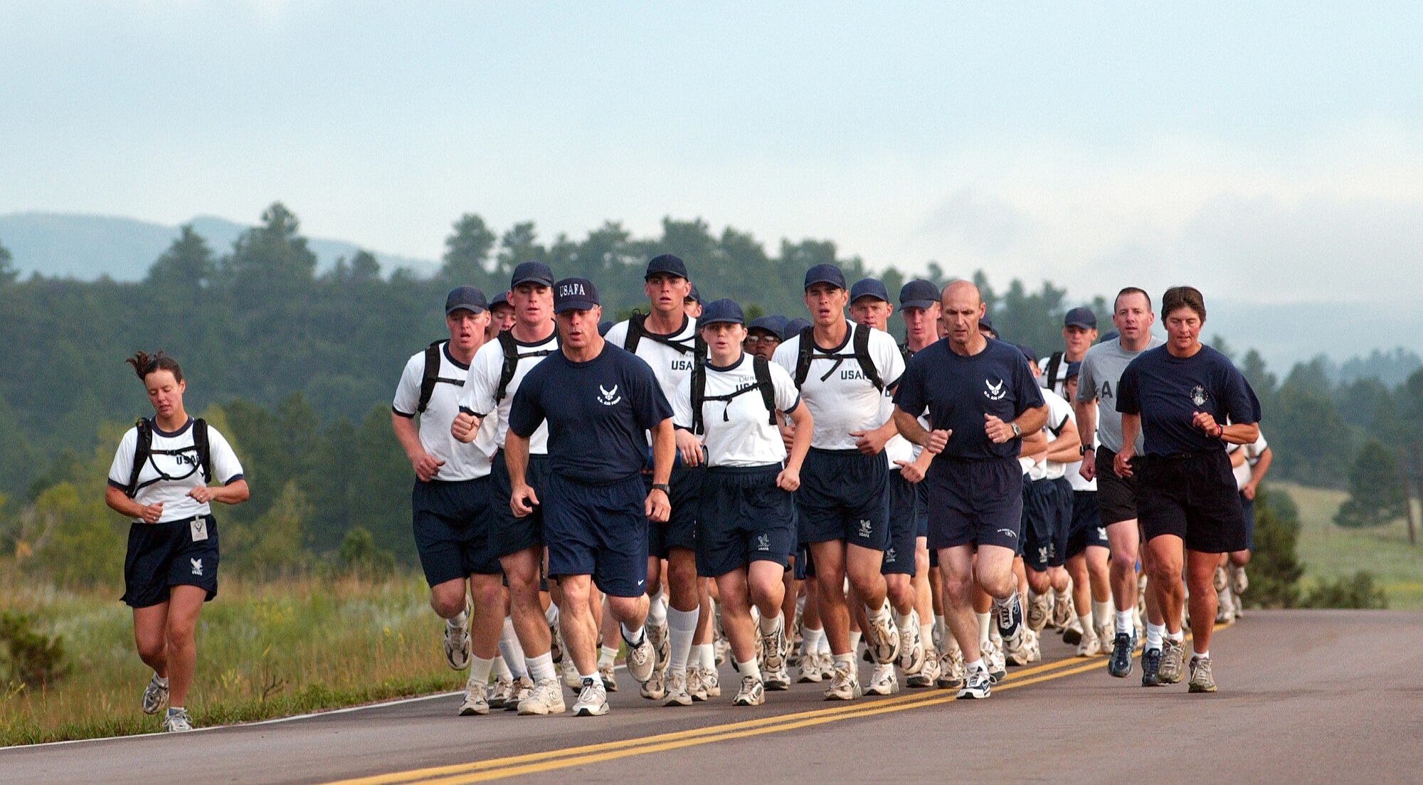 U.S. AIR FORCE ACADEMY, Colo. -- The commandant of cadets, Brig. Gen. John Weida (blue shirt and hat), leads the Class of 2008 on its 36-mile relay "Warrior Run."  The relay began at the school's Jacks Valley training area then meandered through Pike National Forest. The 11-leg, seven-hour run is the final event for the class's basic cadet training.  (U.S. Air Force photo by Ken Wright)   