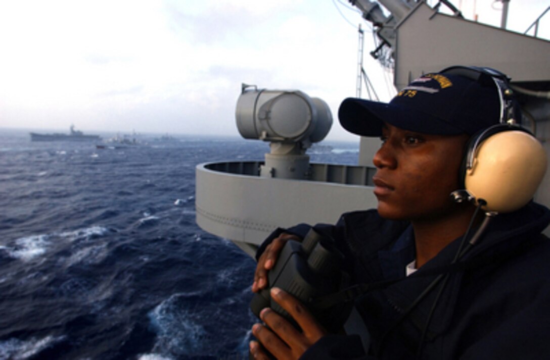 Seaman Michael Watson stands the lookout watch on the signal bridge of the aircraft carrier USS Harry S. Truman (CVN 75) as the ship operates in the Atlantic Ocean during exercise Summer Pulse 2004 on July 12, 2004. Summer Pulse 2004 is a Navy exercise where seven aircraft carrier strike groups will learn new ways of operating, training, manning and maintaining their fleet. 