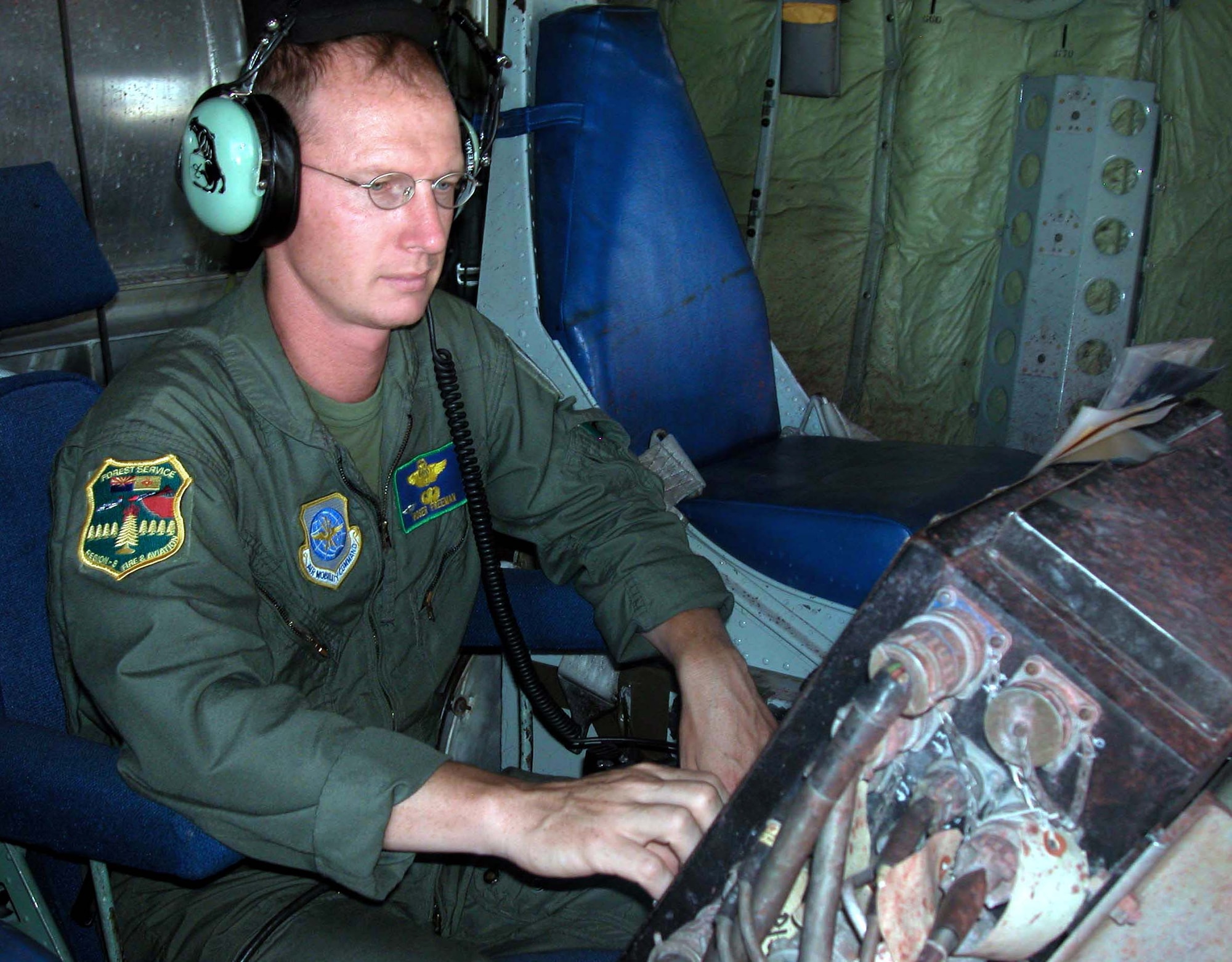 HILL AIR FORCE BASE, Utah (AFPN) -- Master Sgt. Tom Freeman checks gauges on a "Modular Airborne FireFighting System" before takeoff aboard a C-130 Hercules.  Sergeant Freeman is an Air Force Reserve loadmaster with the 302nd Airlift Wing.  The wing and three Air National Guard units, the sole aerial firefighting support for the Air Force, have been helping wild fires this season.  (Courtesy photo)
