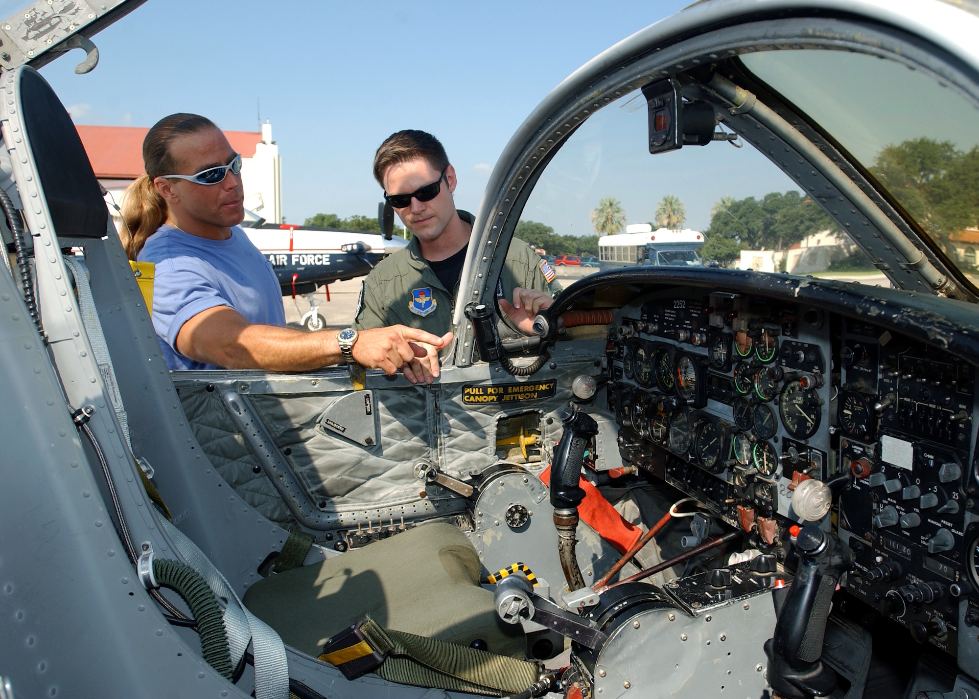 RANDOLPH AIR FORCE BASE, Texas (AFPN) -- Capt. Matt Gehrke shows professional wrestler Shawn Michaels the cockpit of a T-37 Tweet.  The wrestler, who spent a portion of his childhood here, toured the base Aug. 4.  Captain Gehrke is assigned to the 559th Flying Training Squadron.  (U.S. Air Force photo by Master Sgt. Lee Roberts)