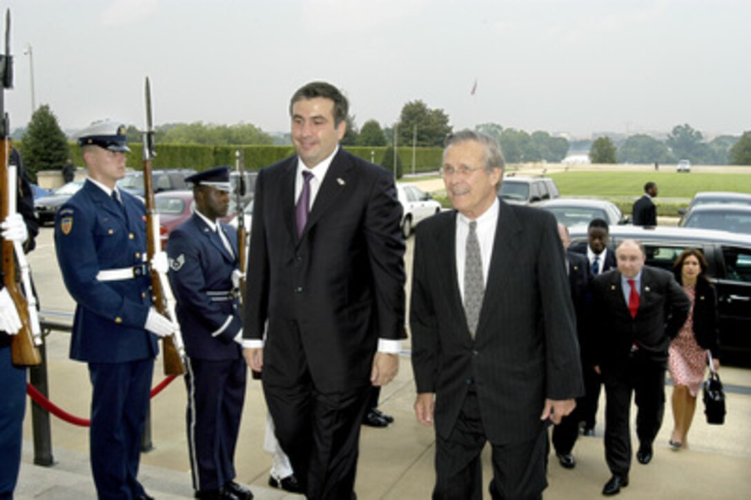Secretary of Defense Donald H. Rumsfeld (right) escorts Georgian President Misha Saakashvili through an honor cordon and into the Pentagon on Aug. 4, 2004. The two will meet with their senior advisors to discuss a broad range of security issues of interest to both nations. 