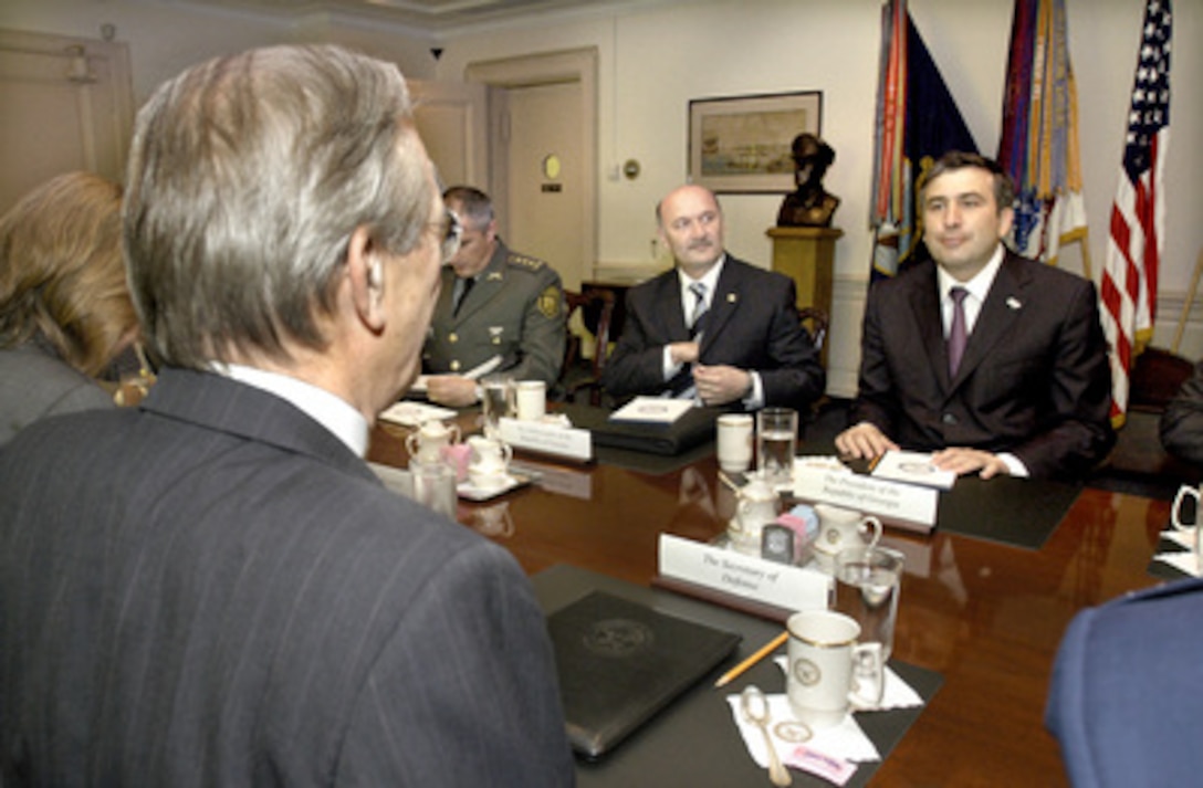 Georgian President Misha Saakashvili (right) meets with Secretary of Defense Donald H. Rumsfeld (foreground) in the Pentagon on Aug. 4, 2004. Saakashvili and Rumsfeld are meeting to discuss a broad range of security issues of interest to both nations. Among those joining Saakashvili for the talks are Georgian Ambassador Levan Mikeladze (center) and Defense Attaché Col. Archil Tsintsadze. 