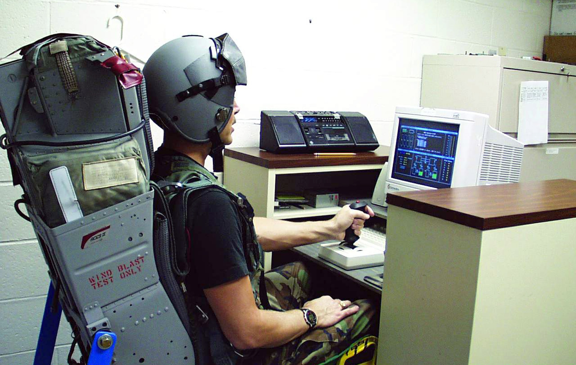 WRIGHT-PATTERSON AIR FORCE BASE, Ohio -- A volunteer test subject sits in a mock-up ejection seat at the Air Force Research Laboratory's human effectiveness directorate here.  The seat is fitted with a special device that measures how much pressure is being exerted on the seat cushion and where the "hot spots" are located.  Those "hot spots" can cause reduced blood flow leading to blood clots and other physiological problems.  The goal of the testing is to develop improved cushions.  (U.S. Air Force photo by Joseph Pellettiere)
