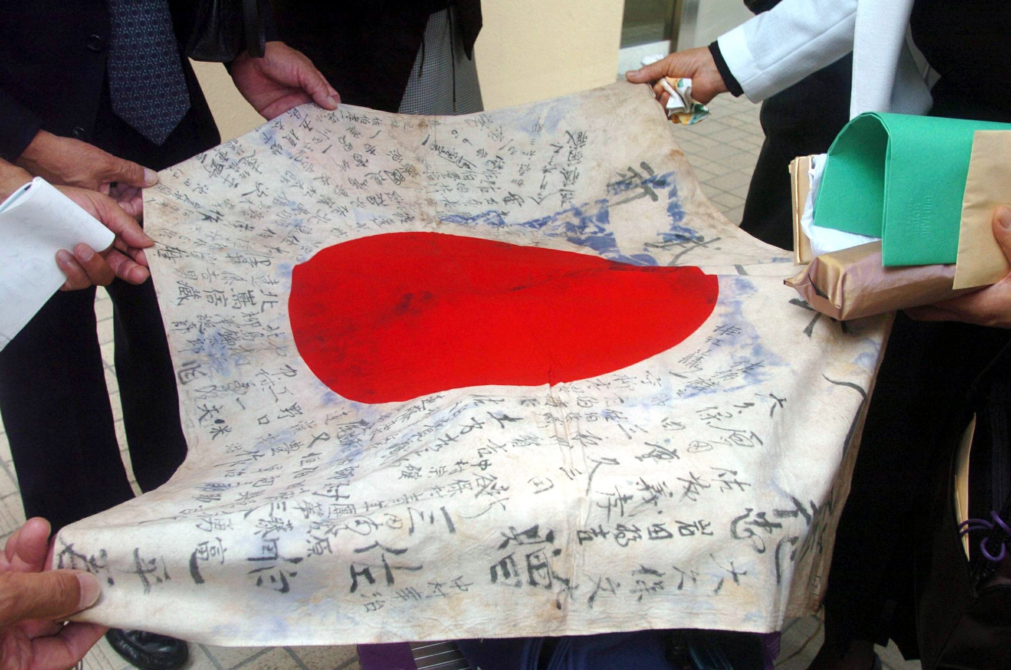 YOKOTA AIR BASE, Japan -- A flag belonging to Ippei Saeki, a Japanese soldier who died fighting against American forces during World War II, was returned to his family during a ceremony here Aug. 6.  The flag was signed and given Mr. Saeki by his friends and relatives before he went off to fight in the war.  (U.S. Air Force photo by Master Sgt. Val Gempis)