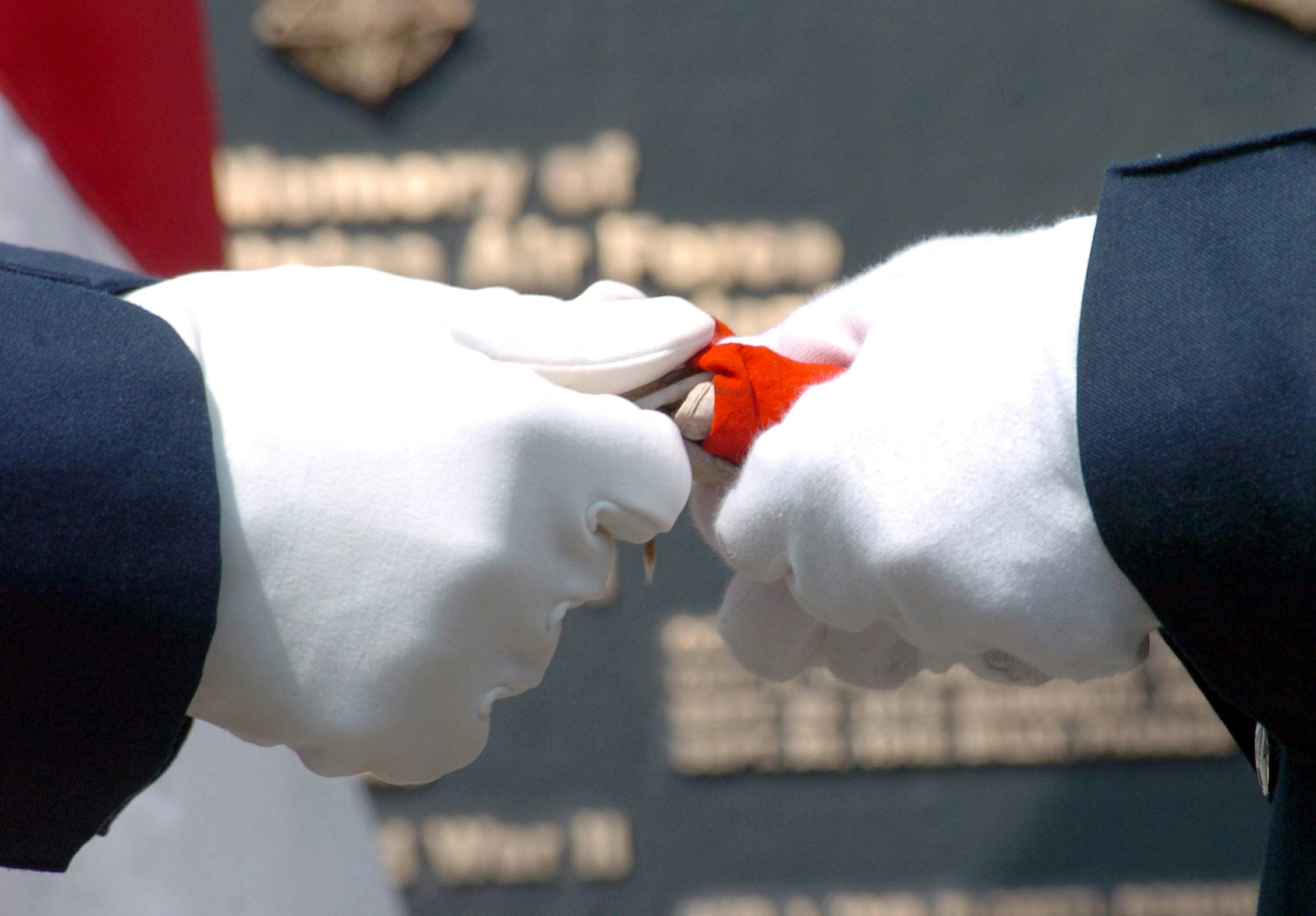 YOKOTA AIR BASE, Japan -- Airmen from the 374th Airlift Wing Honor Guard fold a Japanese flag belonging to Ippei Saeki who died fighting against American forces during World War II.  The flag was presented to his younger brother during a ceremony here Aug. 6.  (U.S. Air Force photo by Master Sgt. Val Gempis)