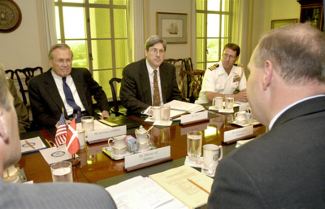 Secretary of Defense Donald H. Rumsfeld (left) hosts a meeting in the Pentagon with Danish Minister of Defense Soren Gade (right foreground) on Aug. 9, 2004. The two defense leaders and their senior advisors are meeting to review a broad range of bilateral security issues. Joining Rumsfeld on the U.S. side of the table are Under Secretary of Defense for Policy Douglas Feith (center) and the defense attaché at the U.S. Embassy in Copenhagen Capt. Jeff Pack, U.S. Navy. 