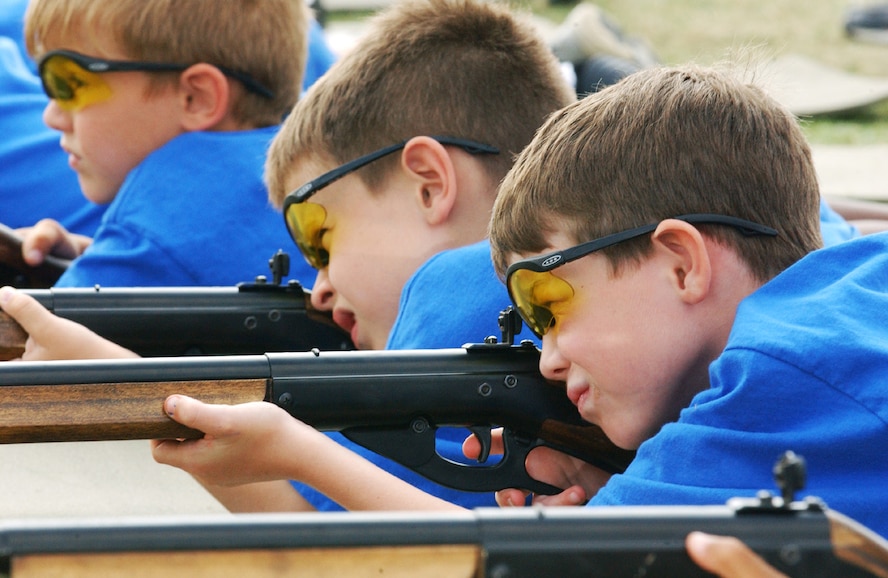 ROYAL AIR FORCE FELTWELL, England -- Duncan York (right), John Slife (middle) and Triston Williams aim their rifles at the BB gun and archery station here July 28. The boys were shooting the rifles during a week long "Way Out West" Cub Scouts day camp. There were more than 100 volunteers from RAF s Mildenhall, Lakenheath and Feltwell involved in running the camp's activities. (U.S. Air Force photo by Airman 1st Class Cecil Carlos McCloud)