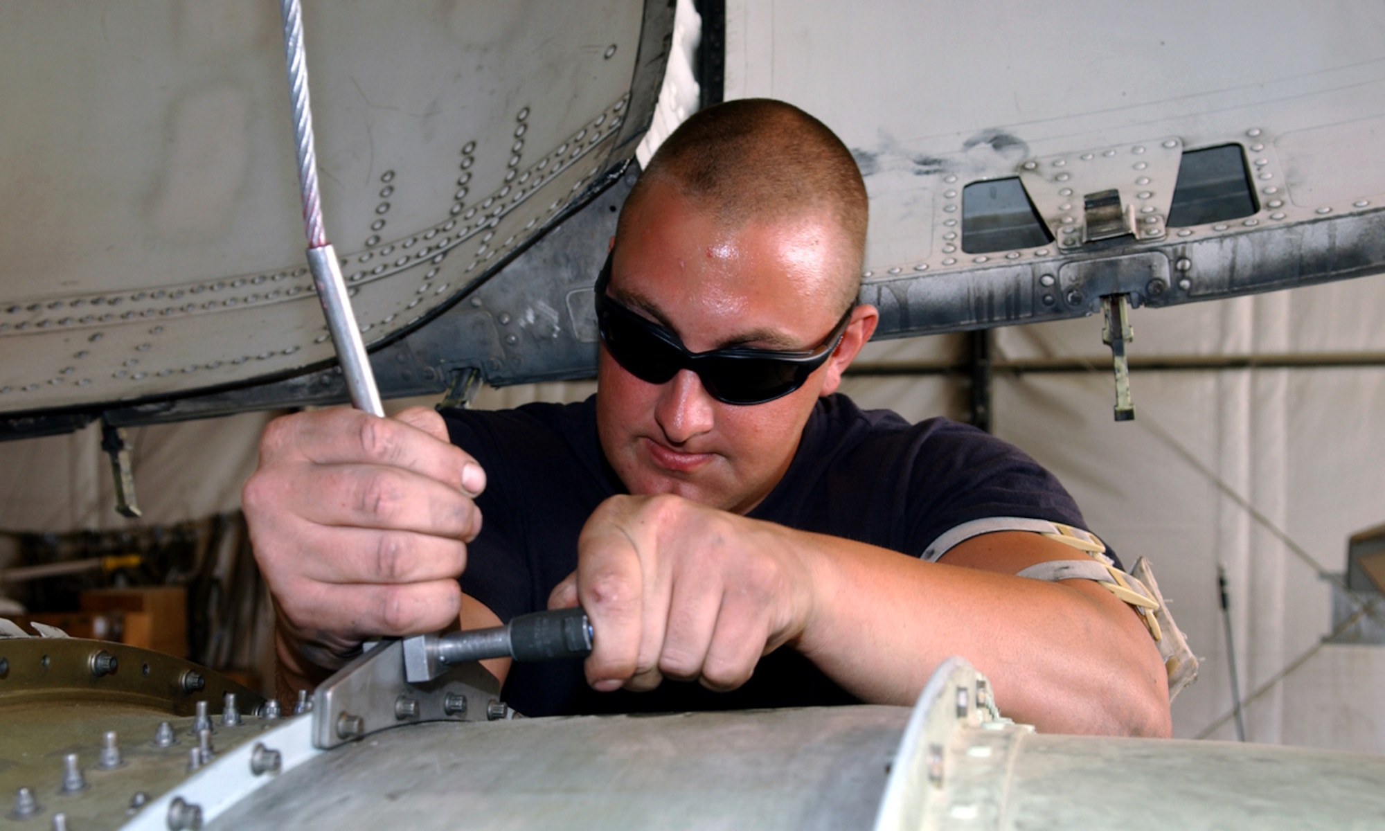 BAGRAM AIR BASE, Afghanistan -- Staff Sgt. James Manix connects an A-10 Thunderbolt II engine to a hoist cable before removing it.  Sergeant Manix is assigned to the 354th Expeditionary Aircraft Maintenance Squadron.  (U.S. Air Force photo by Master Sgt. Andrew Gates)