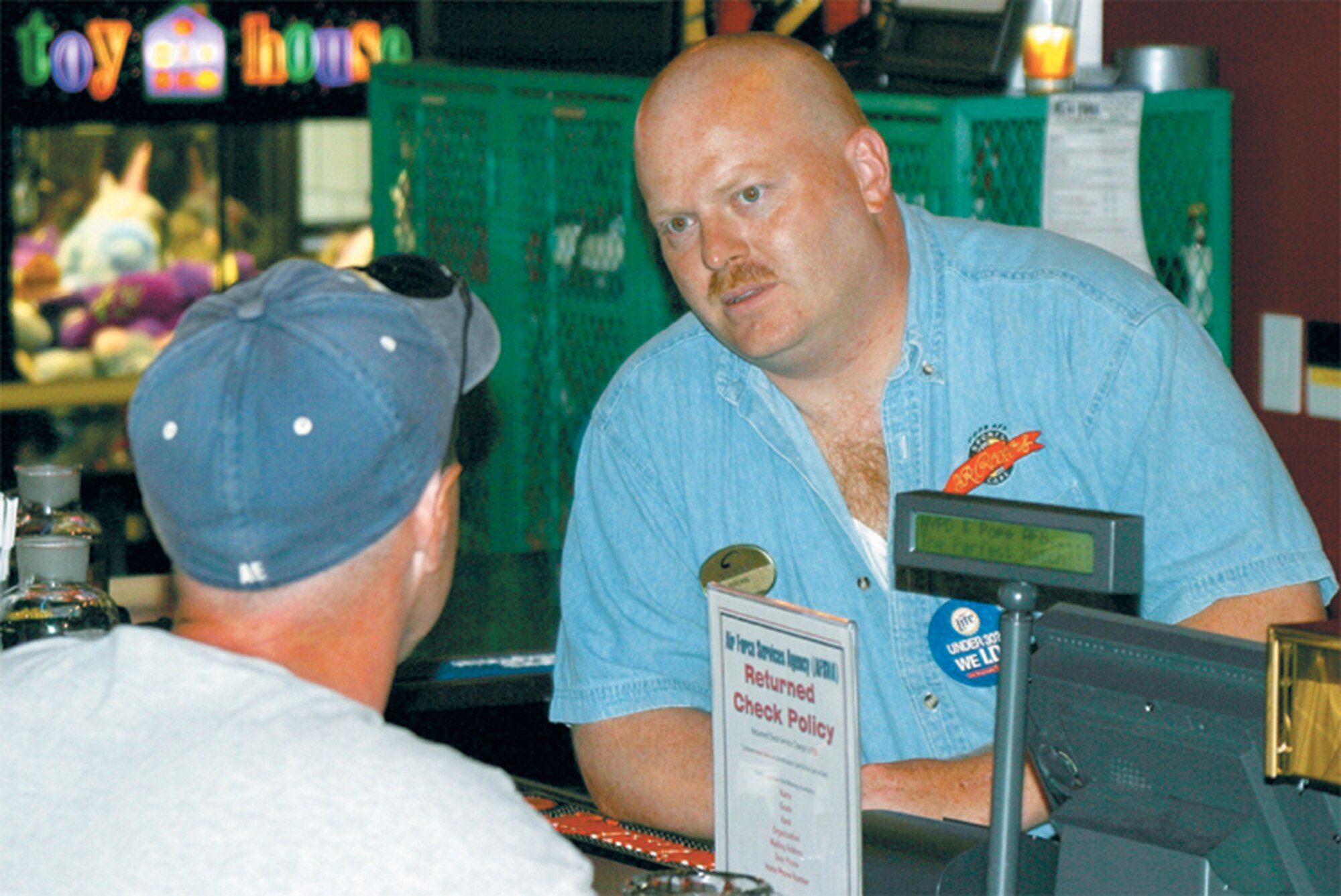 POPE AIR FORCE BASE, N.C. -- Talking with one of the patrons at J.R. Rocker's sports bar here, Staff Sgt. Brian Miller keeps close tabs on his customers' sobriety.  He frequently suggests Airmen Against Drunk Driving as a safe option for getting home.  Sergeant Miller is assigned to the 2nd Airlift Squadron.  (U.S. Air Force photo by Claire Dattilo)
