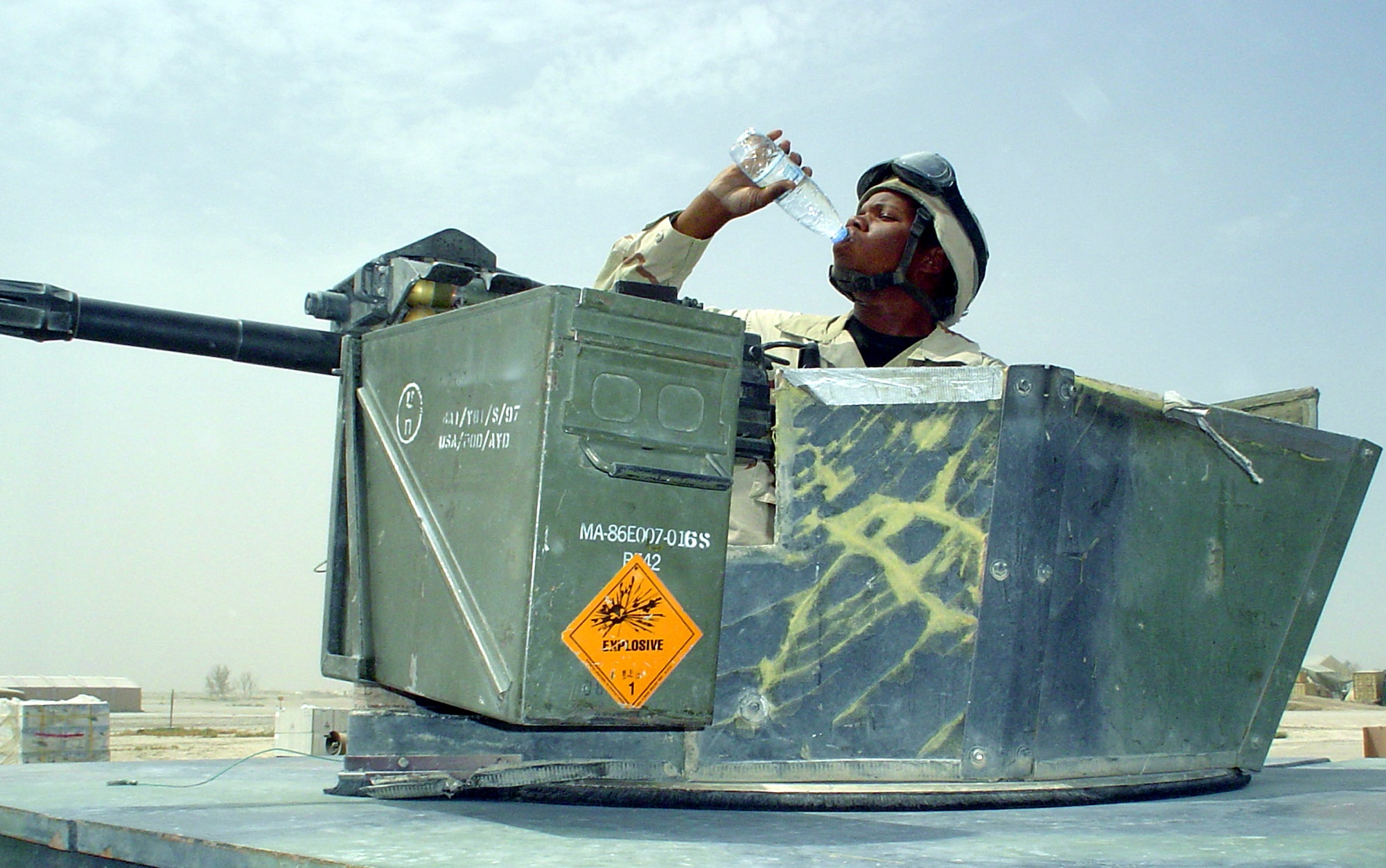 TALLIL AIR BASE, Iraq -- Senior Airman Maurice Brown takes a water break while on patrol here.  He is a weapons-platform gunner with the 407th Expeditionary Security Forces Squadron.  With temperatures routinely topping 120 degrees, base leaders stress drinking plenty of water throughout the day to stay hydrated.  (U.S. Air Force photo by Master Sgt. Debbie Aragon)