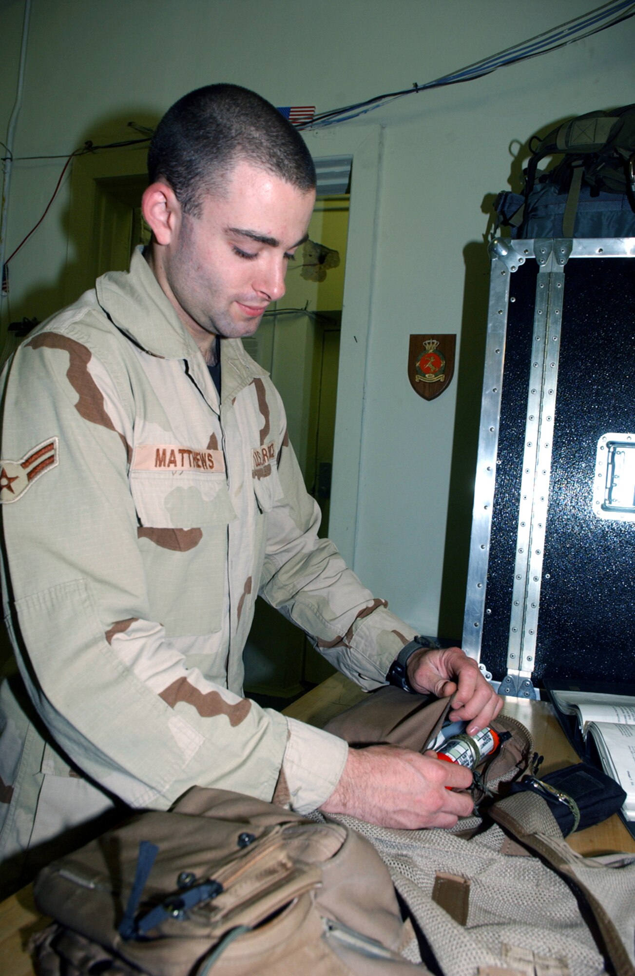 BAGRAM AIR BASE, Afghanistan -- Airman 1st Class Daniel Matthews packs a flare into an A-10 Thunderbolt II pilot's survival vest.  The life-support specialists are responsible for ensuring more than 50 items are prepared each time a pilot heads to the plane.  Airman Matthews is assigned to the 355th Expeditionary Fighter Squadron.  (U.S. Air Force photo by Master Sgt. Andrew Gates)
