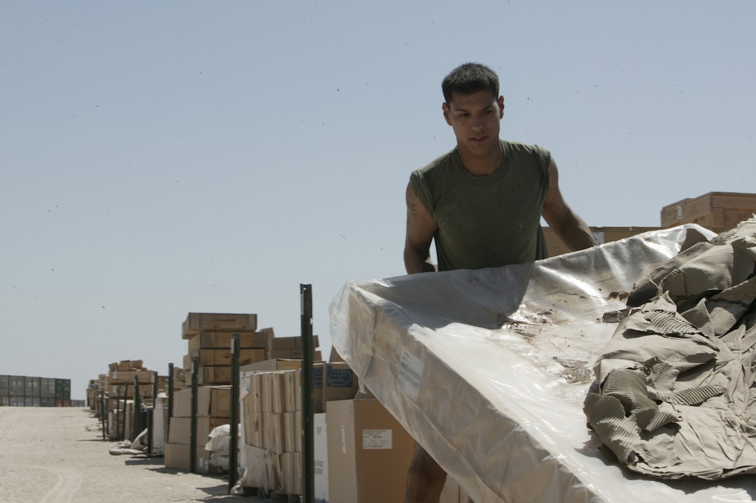 Cpl. Ramon Mendez, a warehouse clerk with Combat Service Support Group 15's Supply Management Unit, gathers gear to fill a supply request on Aug. 16, 2004, at Camp Taqaddum, Iraq. Marines with the SMU, which is part of the 1st Force Service Support Group, receive and distribute supplies for the I Marine Expeditionary Force throughout Iraq. The unit has made several improvements since last year in how supplies are moved throughout a combat zone. Mendez, 22, is from Laredo, Texas. (Photo by Sgt. Matt Epright)