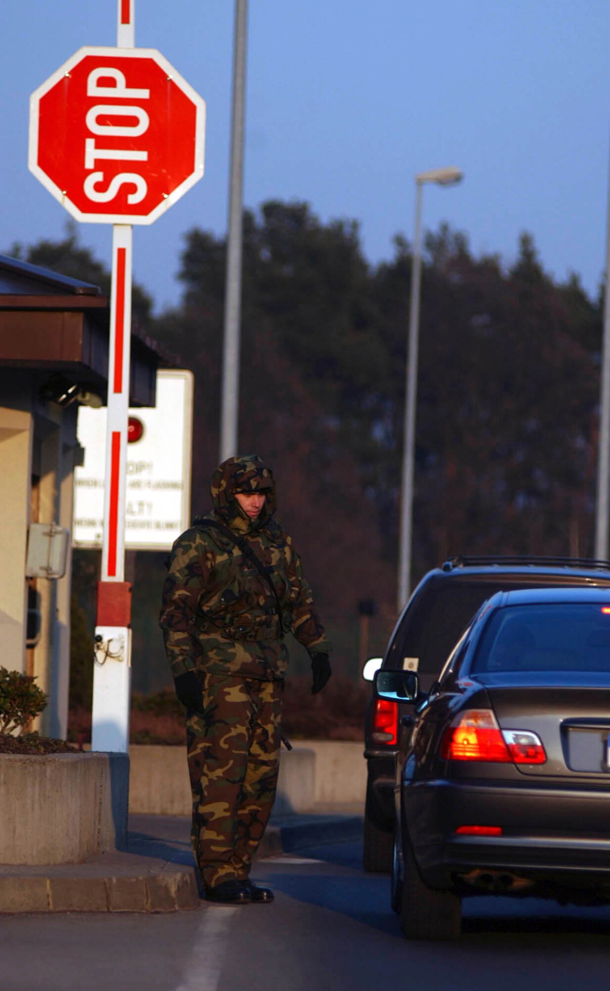 RAMSTEIN AIR BASE, Germany -- Senior Airman Sean Donovan of the 723rd Air Mobility Support Squadron directs traffic at the east gate to Ramstein Air Base, Germany. Donovan augments security forces, which pulls him away for his own job. But when German troops arrive to help at the base gates later this month, he may not have to pull gate guard duty again.  (U.S. Air Force photo by Master Sgt. John Lasky)