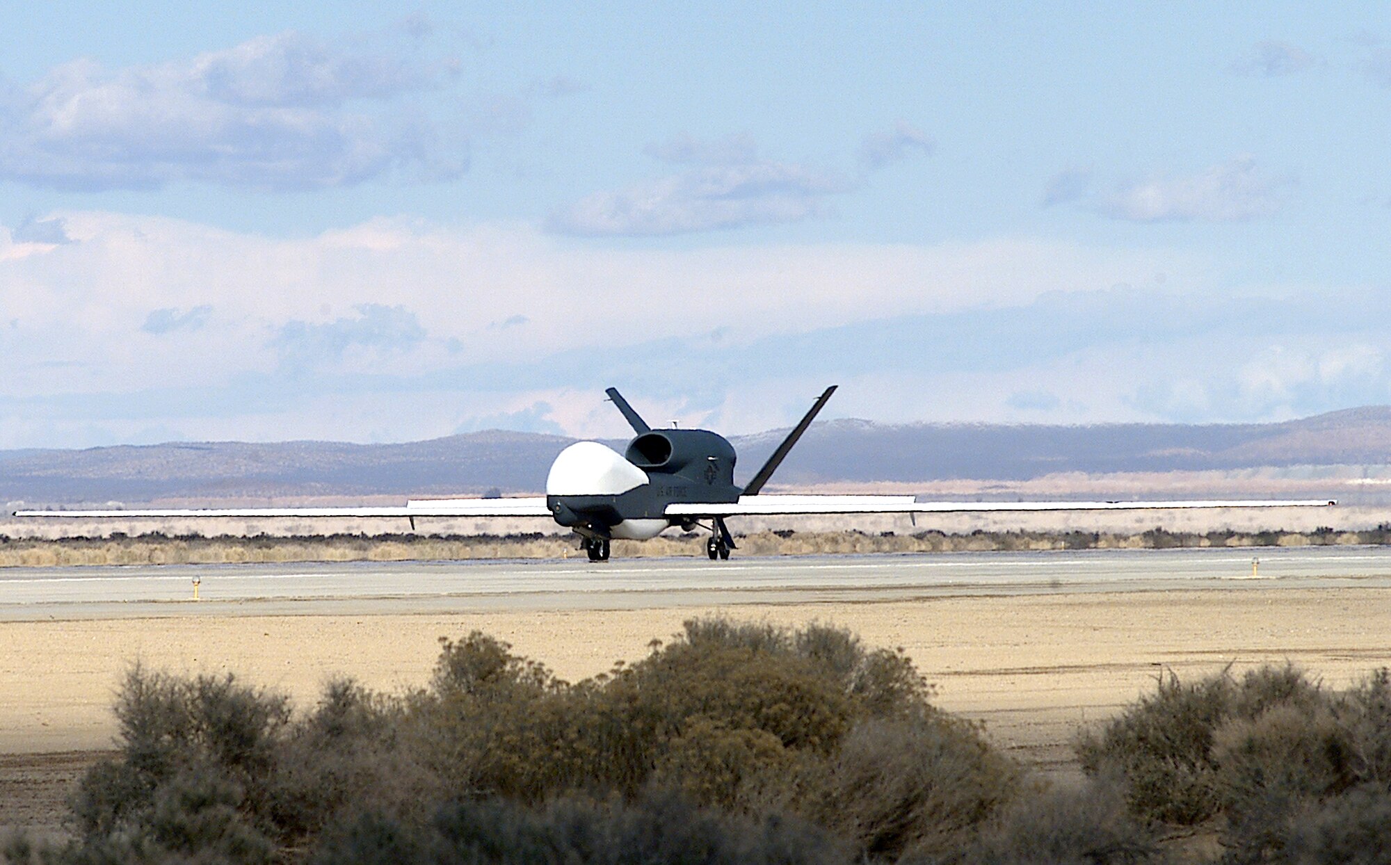 EDWARDS AIR FORCE BASE, Calif. -- The seventh Global Hawk unmanned aerial vehicle lands here after its flight from Air Force Plant 42 in nearby Palmdale, Calif., The UAV was built by lead government contractor Northrop Grumman.  (U.S. Air Force photo by Mike Charlie)