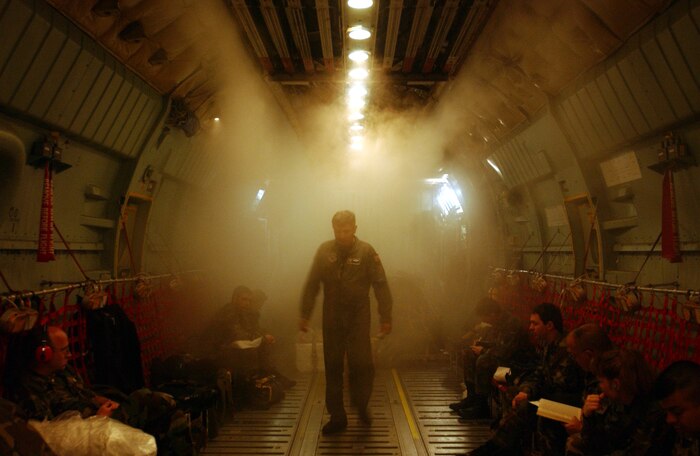 PAGO PAGO, American Samoa (AFPN) -- Master Sgt. Robert Rodarte walks through condensation fog in the rear of a C-141 Starlifter during a mission supporting Operation Deep Freeze. The aircraft had just been refueled here en route to Christchurch, New Zealand. Condensation fog is formed when the air-conditioning system is first turned on in a high-humidity environment. Rodarte is a loadmaster assigned to 729th Airlift Squadron at March Air Reserve Base, Calif.  (U.S. Air Force photo by Staff Sgt Joe Zuccaro)
