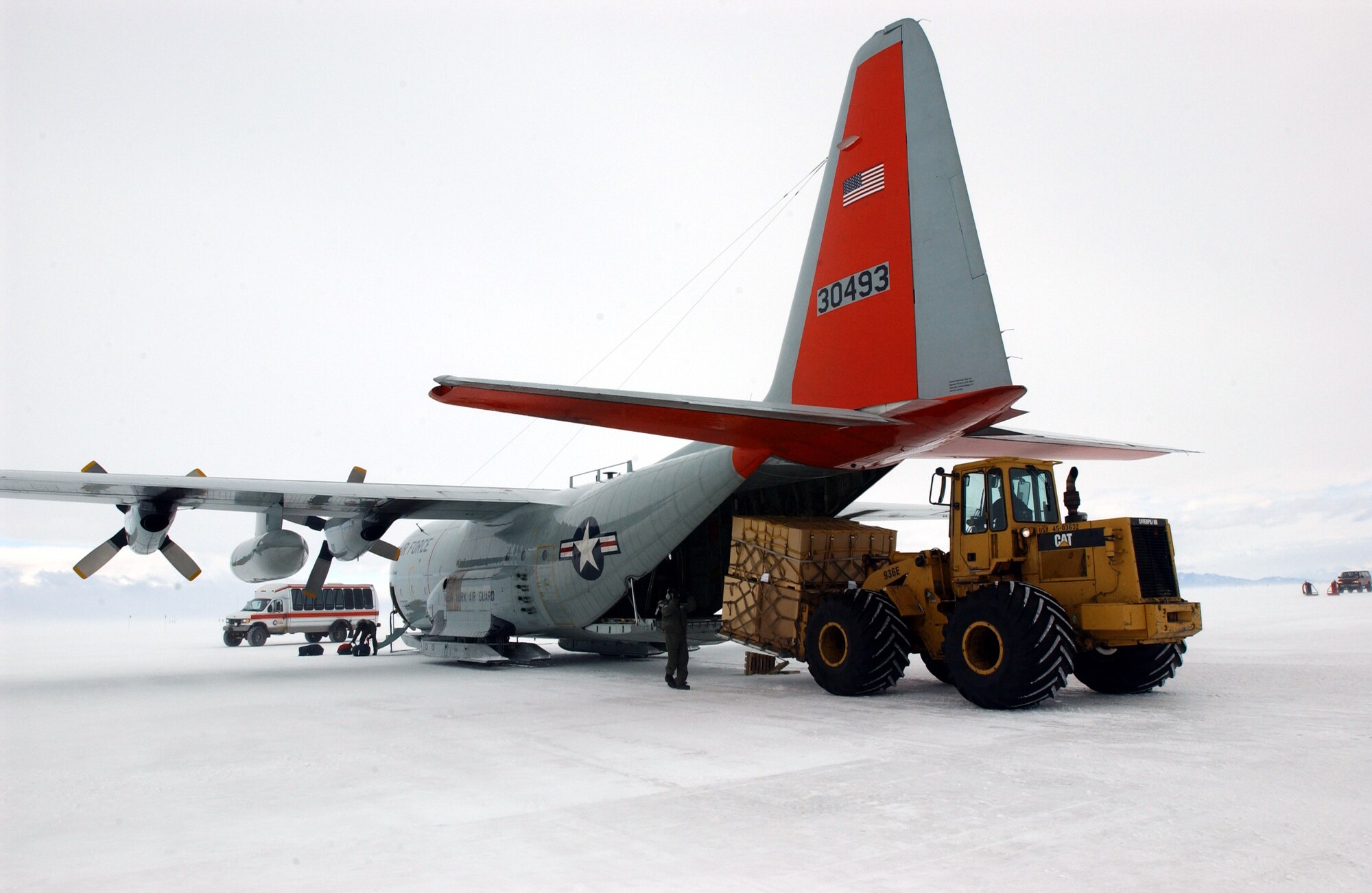 WILLIAMS FIELD, Antarctica (AFPN) -- Master Sgt. Elliot McGuigan directs the unloading of cargo from an LC-130H ski plane here in support of Operation Deep Freeze. McGuigan is assigned to the New York Air National Guard's 139th Airlift Wing at Stratton ANG Base. (U.S. Air Force photo by Staff Sgt. Joe Zuccaro)