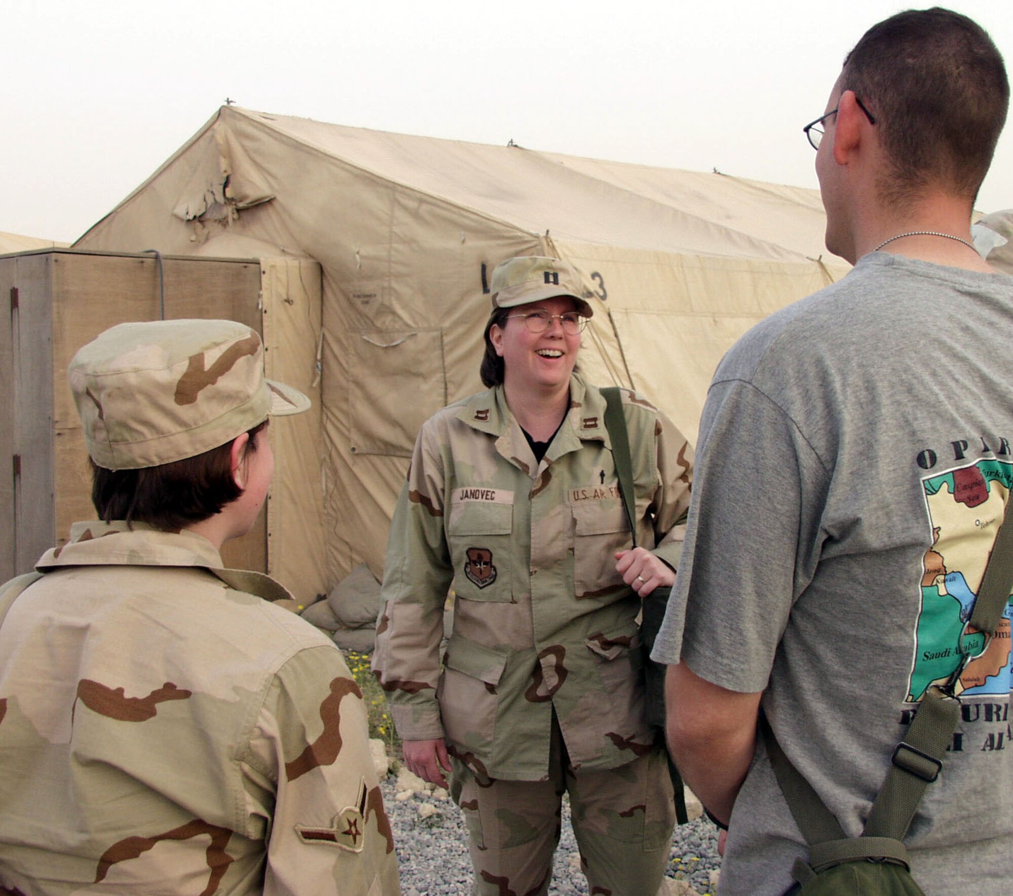 OPERATION SOUTHERN WATCH -- Chaplain (Capt.) Leslie Janovec, a Protestant chaplain assigned to the 386th Air Expeditionary Wing, visits tent city residents at her forward-deployed location in the Arabian Gulf region. Janovec recently deployed to the region from her home station at Lackland Air Force Base, Texas. (U.S. Air Force photo by Tech. Sgt. Dan Neely)