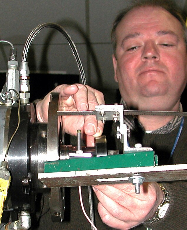 WRIGHT-PATTERSON AIR FORCE BASE, Ohio -- Dr. Nelson Forster readies a bearing test rig for measurement. Nelson, who works for the Air Force Research Laboratory at Wright-Patterson Air Force Base, Ohio, holds five patents. He hopes more young people will follow in his footsteps as the Air Force faces a critical shortage of scientists and engineers.  (U.S. Air Force photo by Michael Kelly)