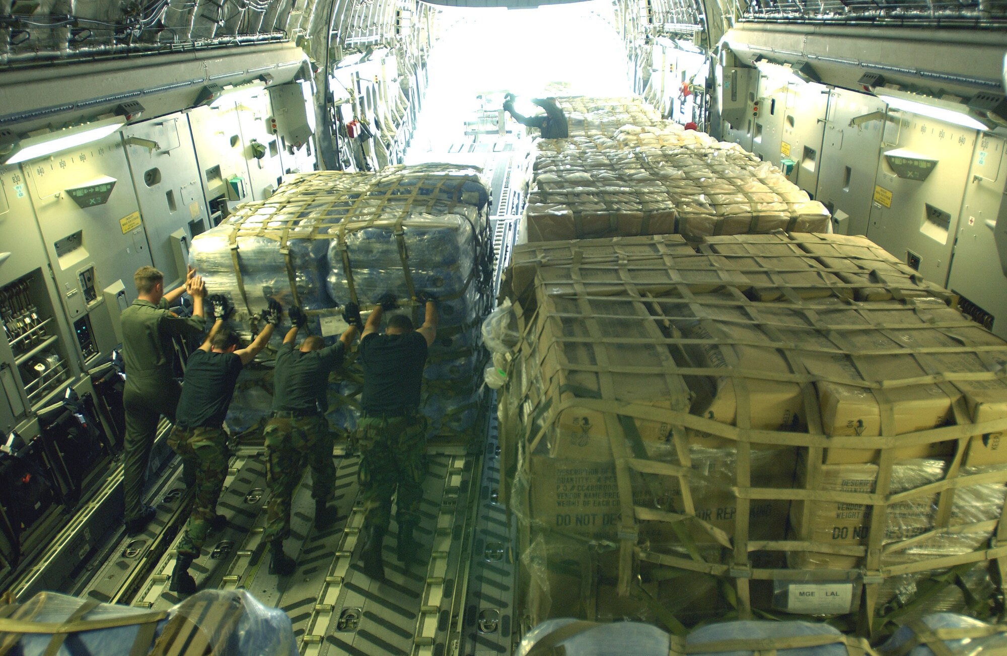 LAKELAND, Fla. -- Airmen of the Tanker Airlift Control Element from McGuire Air Force Base, N.J., unload pallets of relief supplies that arrived here Aug. 15.  Lakeland Regional Airfield has become the center of relief operations in Florida for the Federal Emergency Management Agency.  The U.S. Air Force is providing support by airlifting equipment, people and supplies, expediting the delivery of the items.  (U.S. Air Force photos by Tech. Sgt. Mike Buytas)