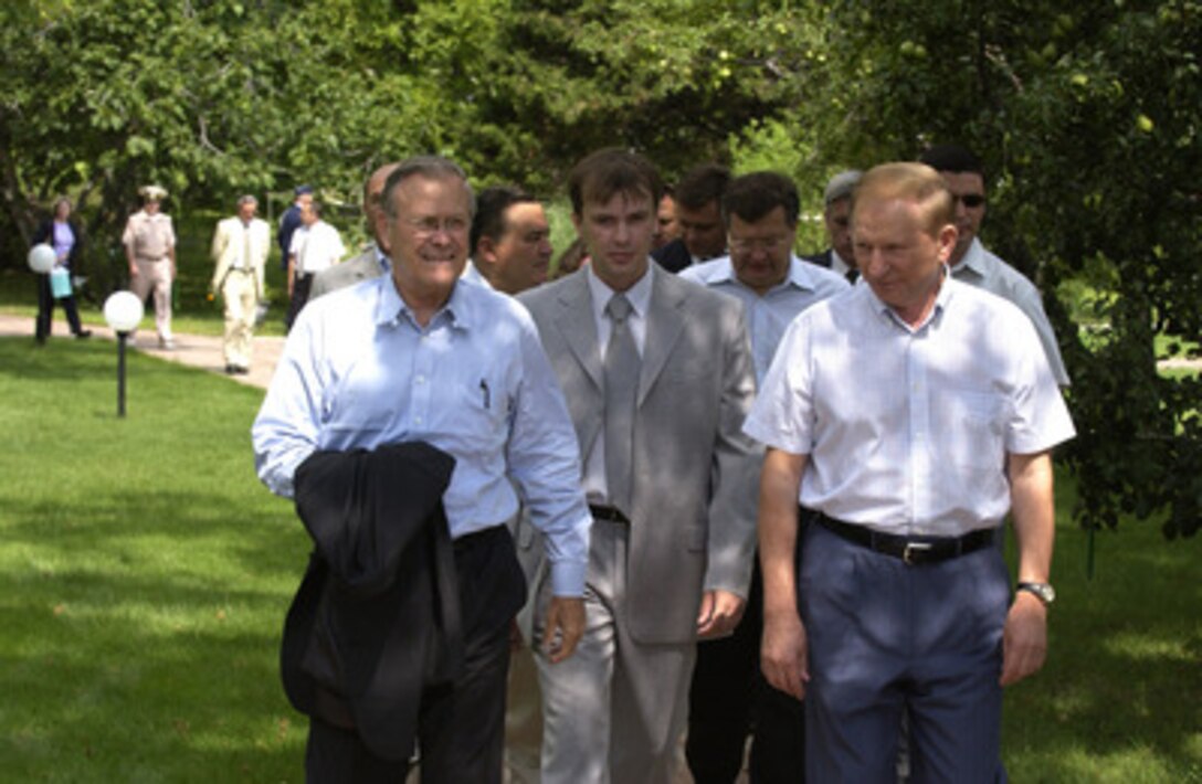 Secretary of Defense Donald H. Rumsfeld (left) strolls the grounds of the Presidential Dacha with Ukrainian President Leonid Kuchma (right) in Partenit, Ukraine, on Aug. 13, 2004. Rumsfeld thanked Kuchma for Ukraine's troop contribution to Iraq and emphasized the importance of Ukrainian relations with NATO. 