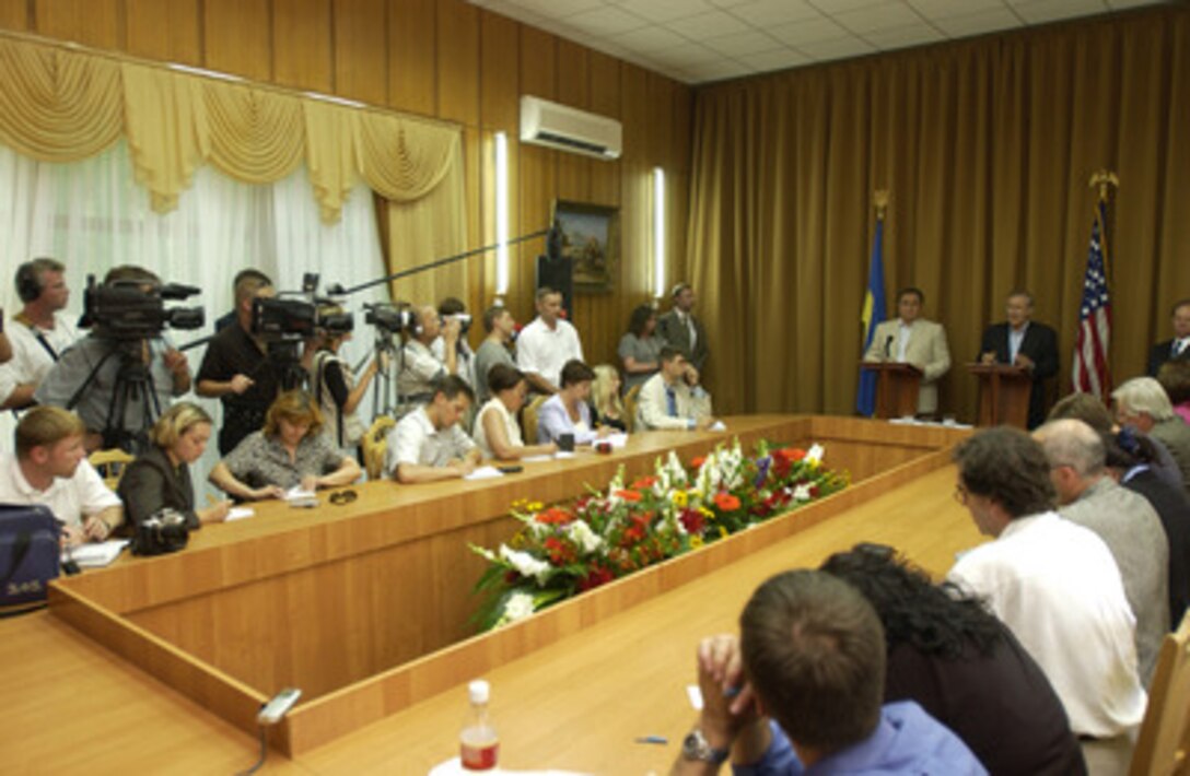 Secretary of Defense Donald H. Rumsfeld (right lectern) and Ukrainian Minister of Defense Yevhan Marchuk address reporters from the Ukraine and the U.S. during a press conference on Aug. 13, 2004. Rumsfeld thanked the Ukraine for its troop contribution to Iraq and highlighted the importance of Ukrainian relations with NATO. 