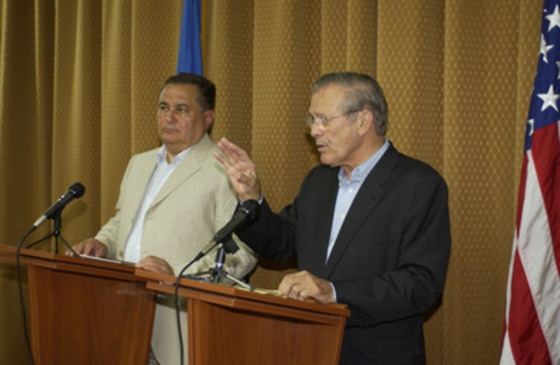 Secretary of Defense Donald H. Rumsfeld (right) and Ukrainian Minister of Defense Yevhan Marchuk address reporters from the Ukraine and the U.S. during a press conference on Aug. 13, 2004. Rumsfeld thanked the Ukraine for its troop contribution to Iraq and highlighted the importance of Ukrainian relations with NATO. 