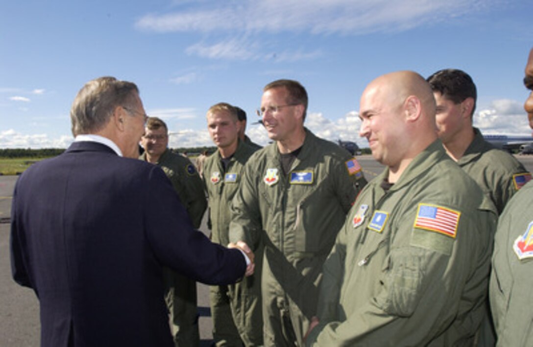 Secretary of Defense Donald H. Rumsfeld shakes hands with U.S. Air Force Tech. Sgt. Johnny Nash at Pulkovo Airport in St. Petersburg, Russia, on Aug. 14, 2004. Rumsfeld was in St. Petersburg to meet with Russian Minister of Defense Sergey Ivanov and discuss U.S.-Russian defense, security relations and regional security issues. Nash is the crew chief of the E-4B aircraft that carried Rumsfeld and his staff on the trip. 