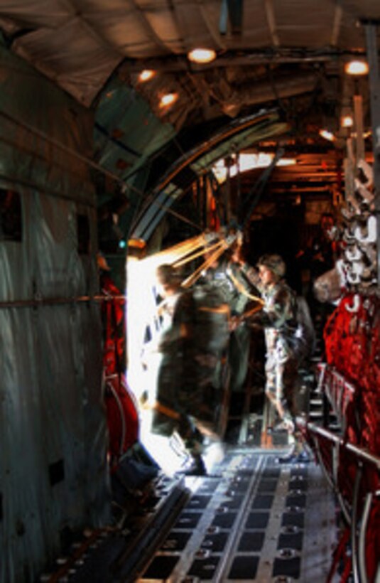 U.S. Army soldiers from the 173rd Airborne Brigade based in Vicenza, Italy, perform a static-line jump from a C-130 Hercules from the 37th Airlift Squadron on Aug. 4, 2004. The 37th Airlift Squadron will drop over 430 personnel and 70,000 pounds of cargo over a two-day period during a Mass Tactical Exercise. 