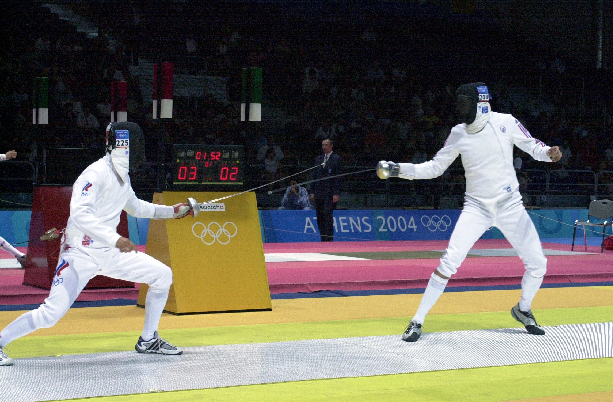 ATHENS, Greece -- Second Lt. Seth Kelsey (right) duels with Russian Ivan Tourchine in the second round of the Olympic Men's Individual Epee event at Helliniko Fencing Hall near here Aug. 17.  Lieutenant Kelsey lost 15-11 and did not advance to the third round.  He is a member of the Air Force world-class athlete program.  (U.S. Air Force photo by Master Sgt. Lono Kollars)