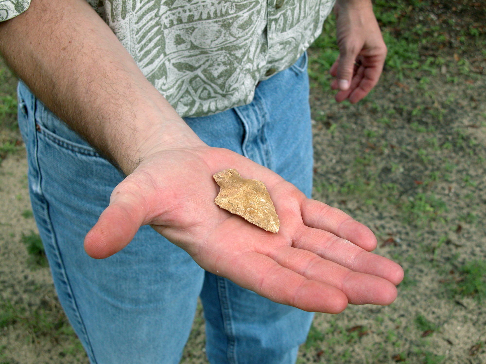 EGLIN AIR FORCE BASE, Eglin -- Mark Stanley displays the American Indian arrowhead found by 6-year-old John David Lilley.  The arrowhead, which dates back to 3,000 to 2,000 B.C., was probably used by descendants of the 18th or 19th century Creeks or Seminoles.  Mr. Stanley is an archaeologist with the environmental program directorate.  (U.S. Air Force photo by Sarah McCaffrey)