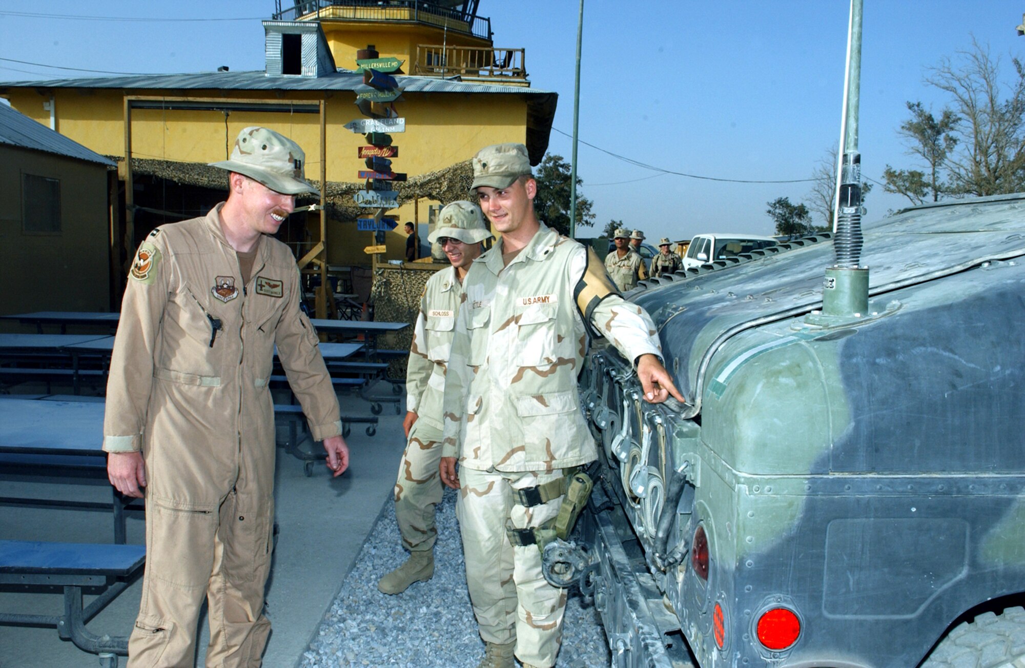 BAGRAM AIR BASE, Afghanistan -- Army Spc. Patrick Little shows Capt. Scott the bullet holes the Humvee he was riding in received during a convoy ambush in Afghanistan.  Captain Scott and his wingman, Capt. Andrew, were on alert and responded to the call in their A-10 Thunderbolt IIs, breaking up the ambush and allowing the convoy to return home.  Speciailst Little is assigned to the 101st Airborne Division, and Captains Scott and Andrew, whose last names are withheld for security reasons, are assigned to the 355th Expeditionary Fighter Squadron here.  (U.S. Air Force photo by Master Sgt. Andrew Gates)