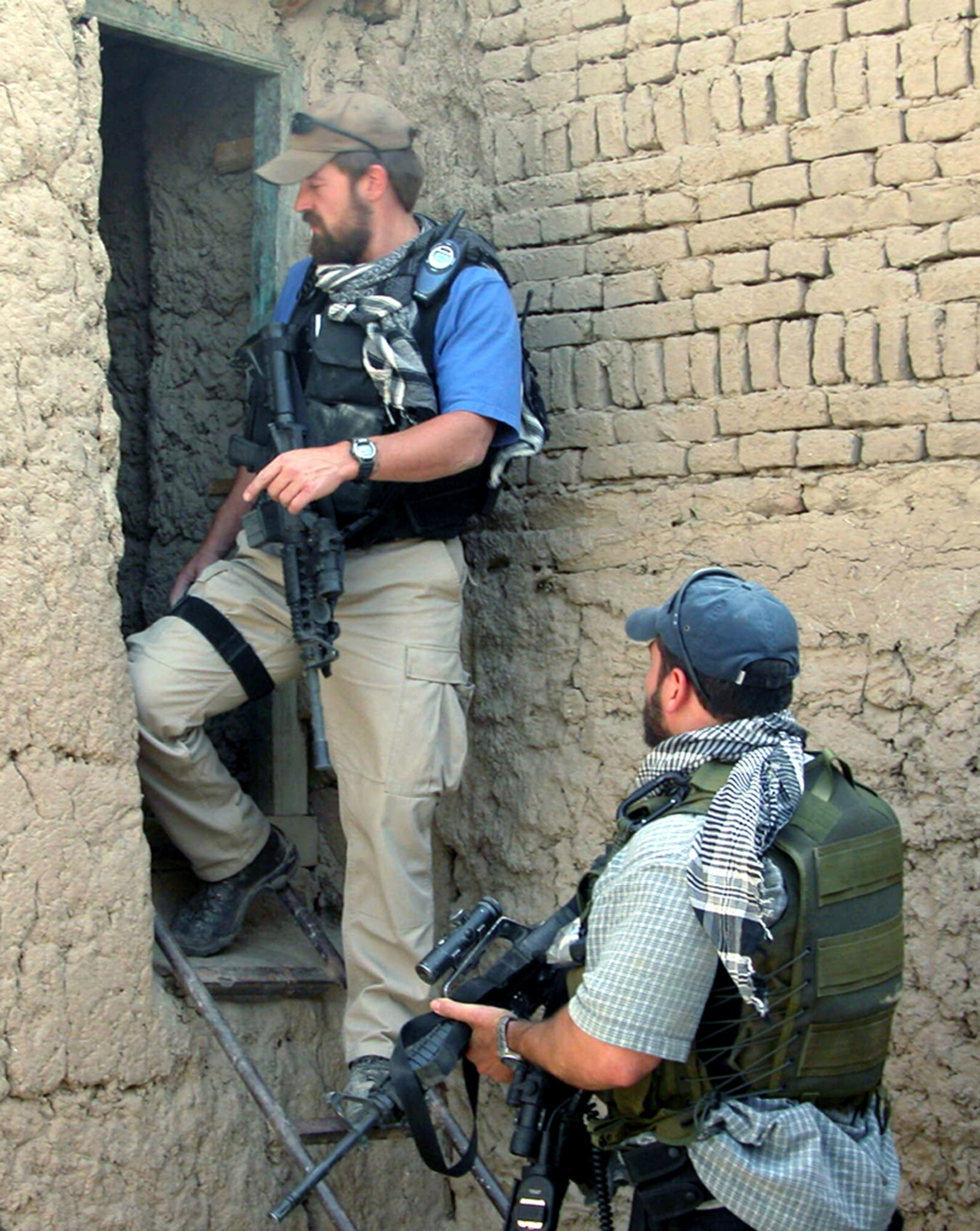 BAGRAM AIR BASE, Afghanistan -- Special Agents Isaac Suydam (left) and Jeff Rutherford search for a weapons cache inside a false wall.  They are assigned to the Air Force Office of Special Investigation detachment here.  (U.S. Air Force photo by Tech. Sgt. Bobbie Jo King)