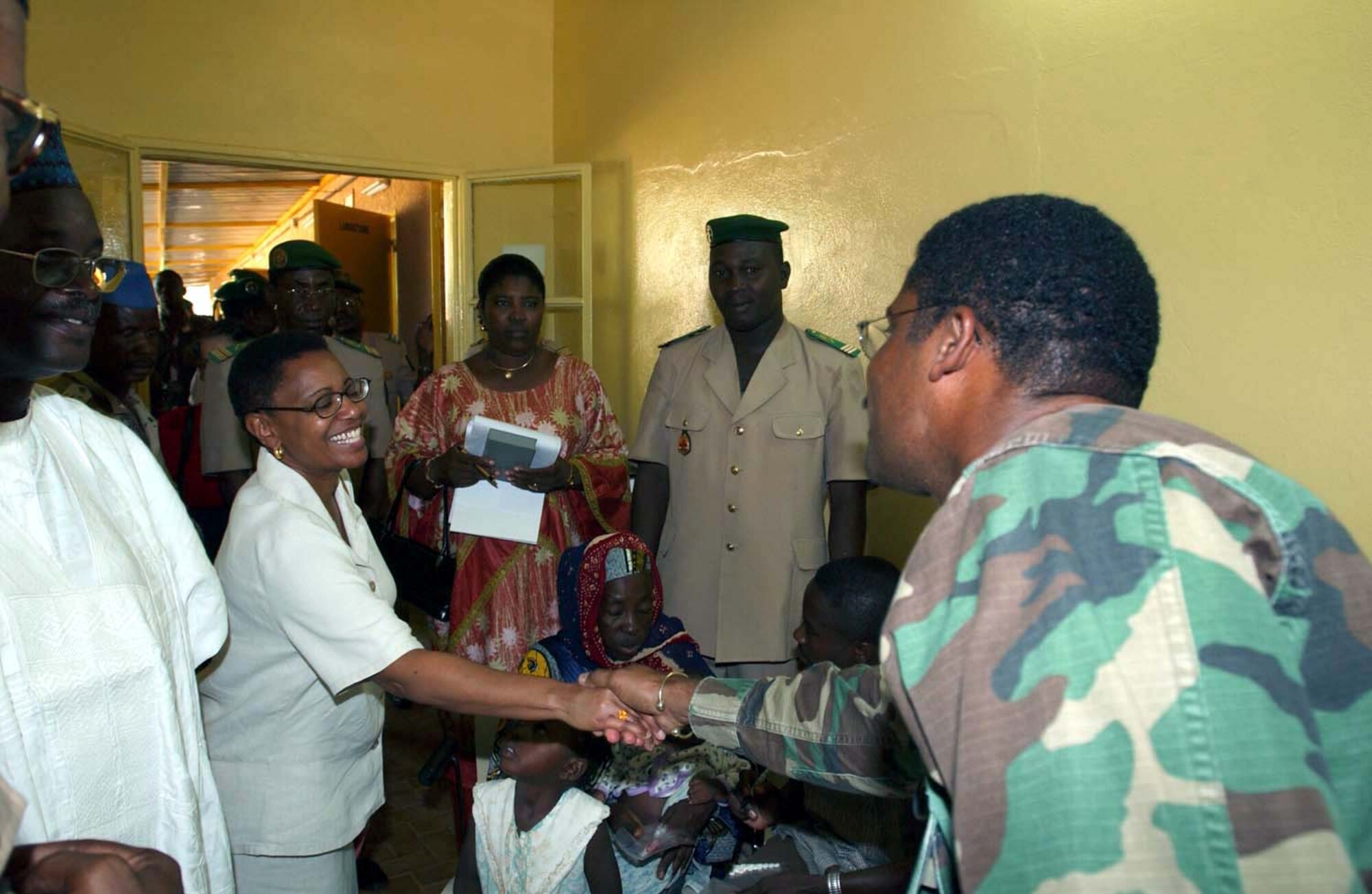 CAMP TONDIBIAH, Niger -- The U.S. Ambassador to Niger, Gail Denise Mathieu, greets Capt. Andrew Gibson during a visit to a local clinic here.  The ambassador was visiting the medical team of 12 Air Force reservists working with the Niger military to provide medical assistance to the villagers.  (U.S. Air Force photo by Tech. Sgt. Chance Babin)