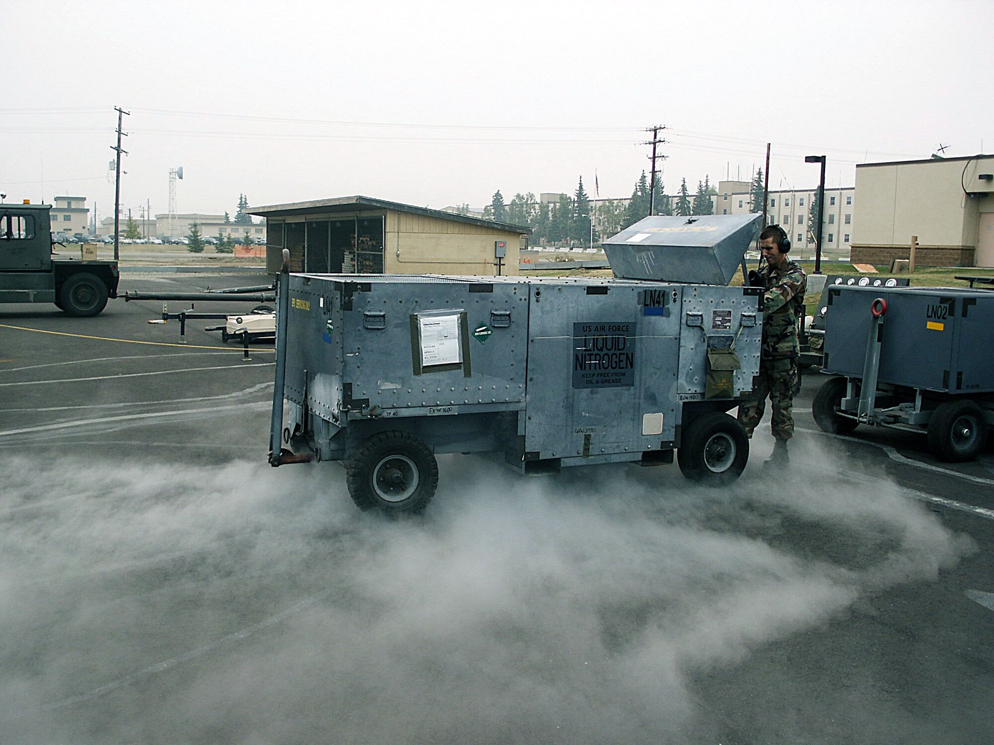 EIELSON AIR FORCE BASE, Alaska -- Airman 1st Class Gary Karlson prepares a liquid nitrogen cart Aug. 19 here during Cope Thunder 04-02.  He is an electrical and environmental specialist with the 77th Fighter Squadron from Shaw Air Force Base, S.C.  (U.S. Air Force photo by Master Sgt. Terry Nelson)