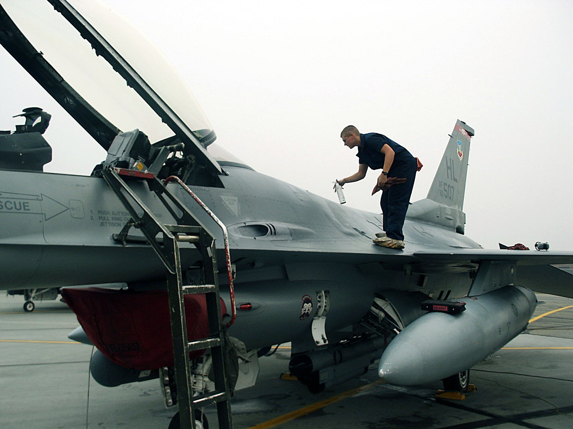 EIELSON AIR FORCE BASE, Alaska -- Staff Sgt. Corey Lobdell wipes down an F-16 Fighting Falcon before a flight here Aug. 19 during Cope Thunder 04-02.  Sergeant Lobdell is a crew chief with the 34th Fighter Squadron from Hill Air Force Base, Utah.  (U.S. Air Force photo by Master Sgt. Terry Nelson)