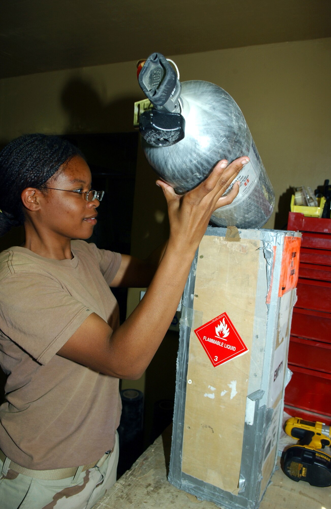 BAGRAM AIR BASE, Afghanistan -- Airman 1st Class Ieisha Smith packs a compressed air sample for shipping.  Airman Smith is assigned to the 455th Expeditionary Logistics Readiness Squadron here and is from Mountain Home Air Force Base, Idaho.  (U.S. Air Force photo by Master Sgt. Andrew Gates)