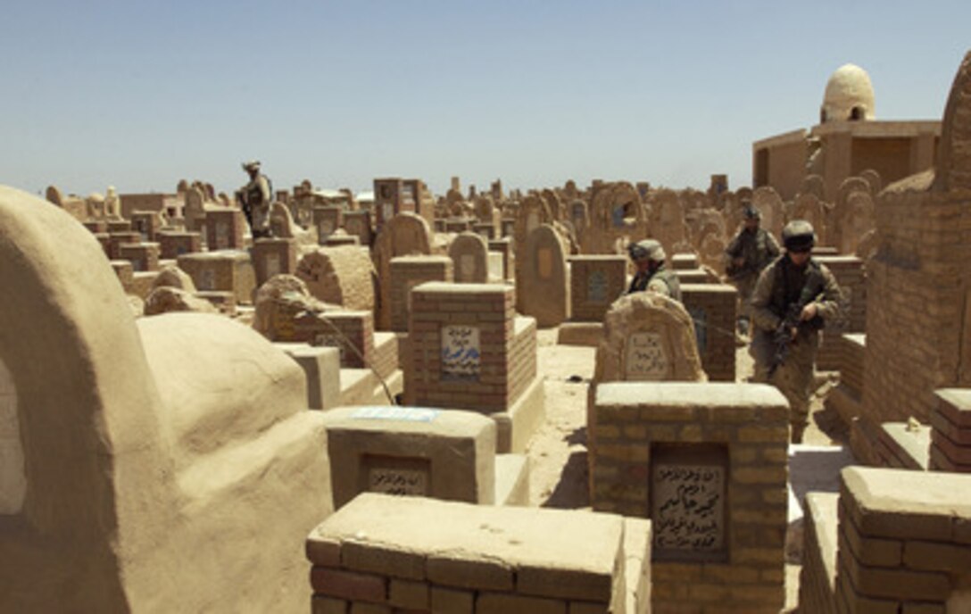 U.S. Army soldiers search through the mausoleums, tombs and catacombs of the An Najaf cemetery on Aug. 15, 2004, for weapons caches, improvised explosive devices, and anti-Iraqi forces that might be hidden there. 
