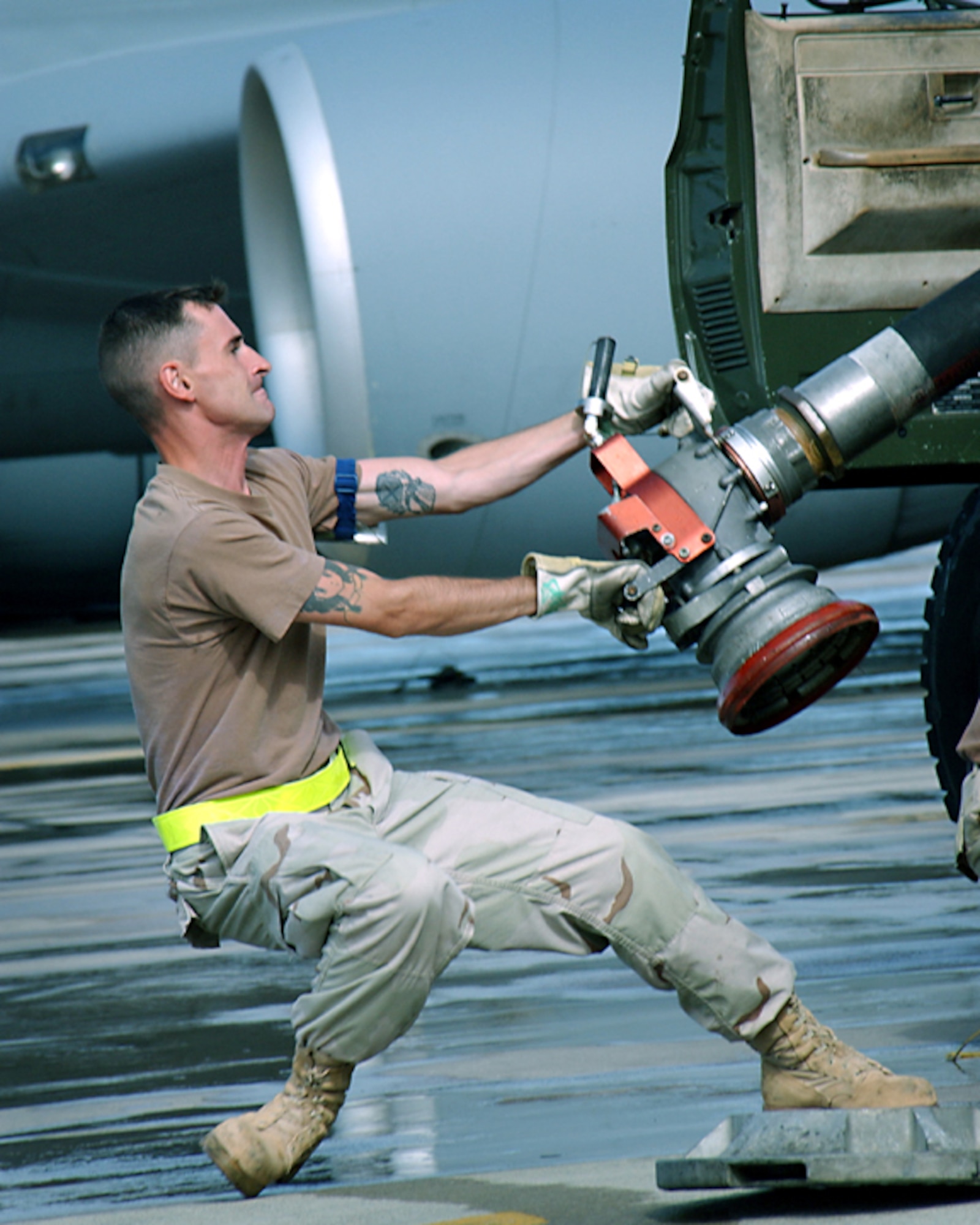 OPERATION ENDURING FREEDOM -- Senior Airman Thomas Haefliger unloads the coupler from a fuel-servicing vehicle.  The fuels element Airmen here have issued more than 10 million gallons of aviation fuel.  Airman Haefliger is a refueling unit operator with the 40th Expeditionary Logistics Readiness Flight fuels element.  He is deployed from Fairchild Air Force Base, Wash.  (U.S. Air Force photo by Master Sgt. Sean Brennan)