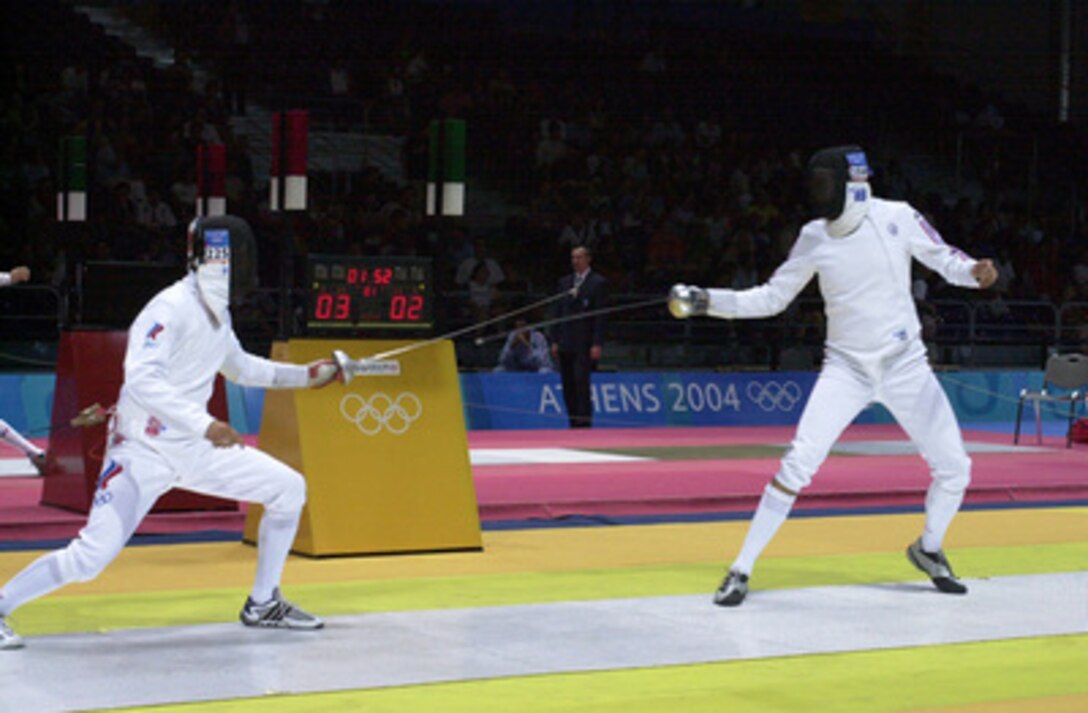 U.S. Air Force 2nd Lt. Weston Kelsey (right) duels for advancement against Russian Ivan Tourchine (left) in the second round of the Olympic Men's Individual Epee event at the Helliniko Fencing Hall just outside Athens, Greece, on Aug. 17, 2004. This was Kelsey's first Olympic attempt and he did not advance to the third round. 