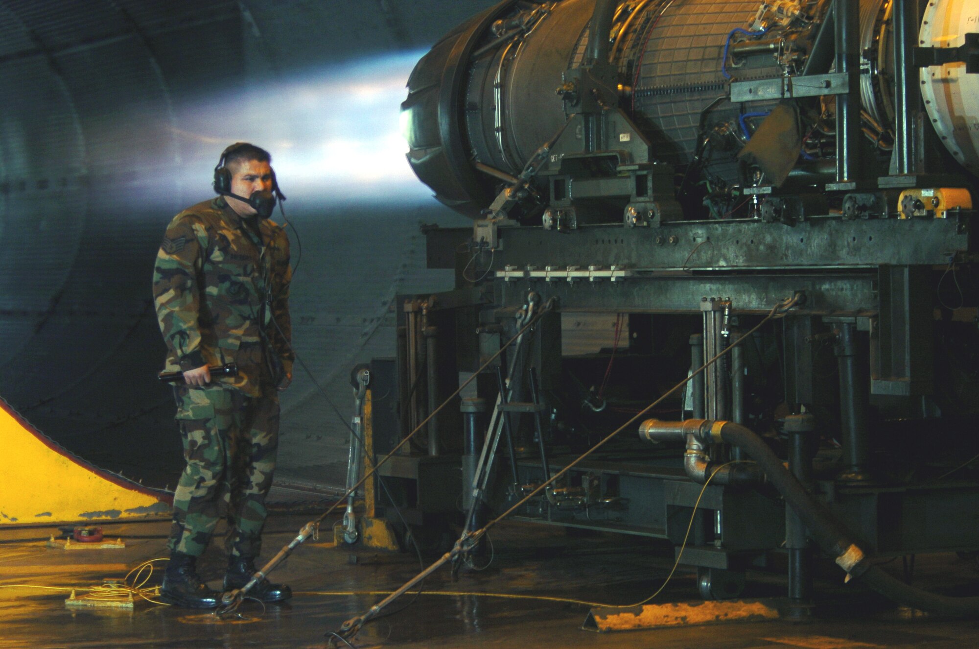 OSAN AIR BASE, South Korea -- Staff Sgt. Daniel Guerra looks for fuel leaks while an F-16 Fighting Falcon engine "runs" full blast at the test cell facility here.  Engine runs ensure that they are in top condition after repairs.  Sergeant Guerra is an engine propulsion mechanic assigned to the 51st Maintenance Squadron.  (U.S. Air Force photo by Master Sgt. Val Gempis) 