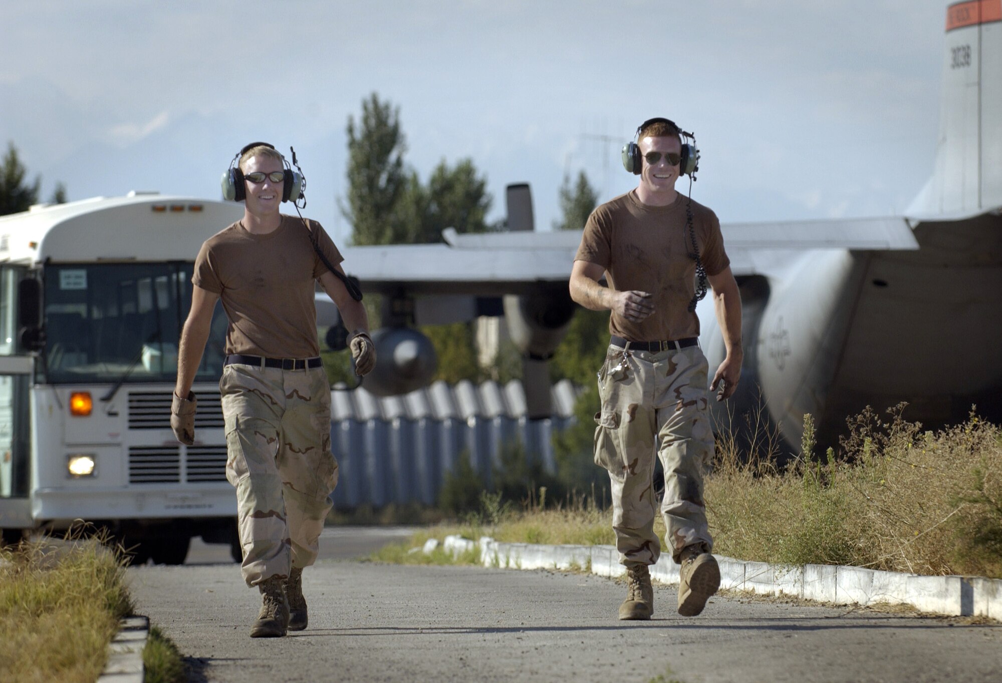 MANAS AIR BASE, Kyrgyzstan -- Senior Airman Derek Smith and Airman 1st Class Alex O'Donnell respond to a request to recover a C-130 Hercules that landed.  They are aircraft maintainers assigned to the 376th Expeditionary Air Maintenance Squadron and are deployed from Little Rock Air Force Base, Ark.  (U.S. Air Force photo by Master Sgt. Scott Wagers)