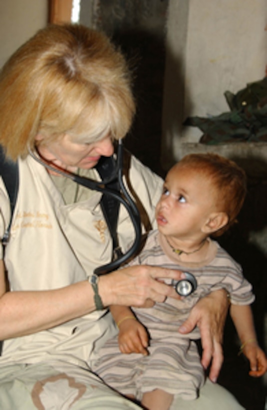 U.S. Army Capt. Cristal Horsch uses a stethoscope to listen as she examines an Afghan child during a Cooperative Medical Assistance mission in the Kunar Province of Afghanistan on Aug. 18, 2004. Task Force 325, Task Force Victory and the Asadabad Provincial Reconstruction Team provided people and animals with medical care. 