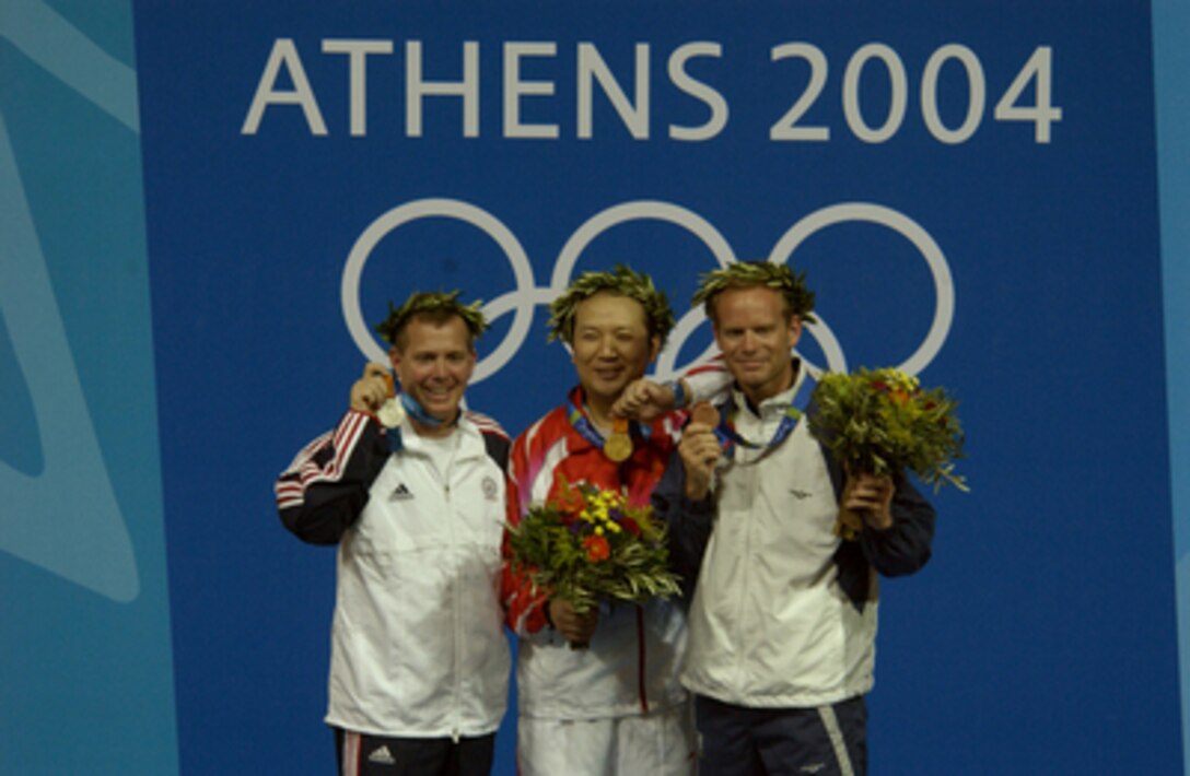 Army Maj. Michael Anti (left) holds up his Silver medal following the 2004 Olympics medal ceremony for the Men's 50m Three-Position Rifle Competition at the Markopoulo Shooting Center in Athens, Greece, on Aug. 22, 2004. Zhanbo Jia from China (center) took the Gold and Christian Planer (right) from Austria took the Bronze. Anti is assigned to the U.S. Army Marksmanship Unit, Fort Benning, Ga. 