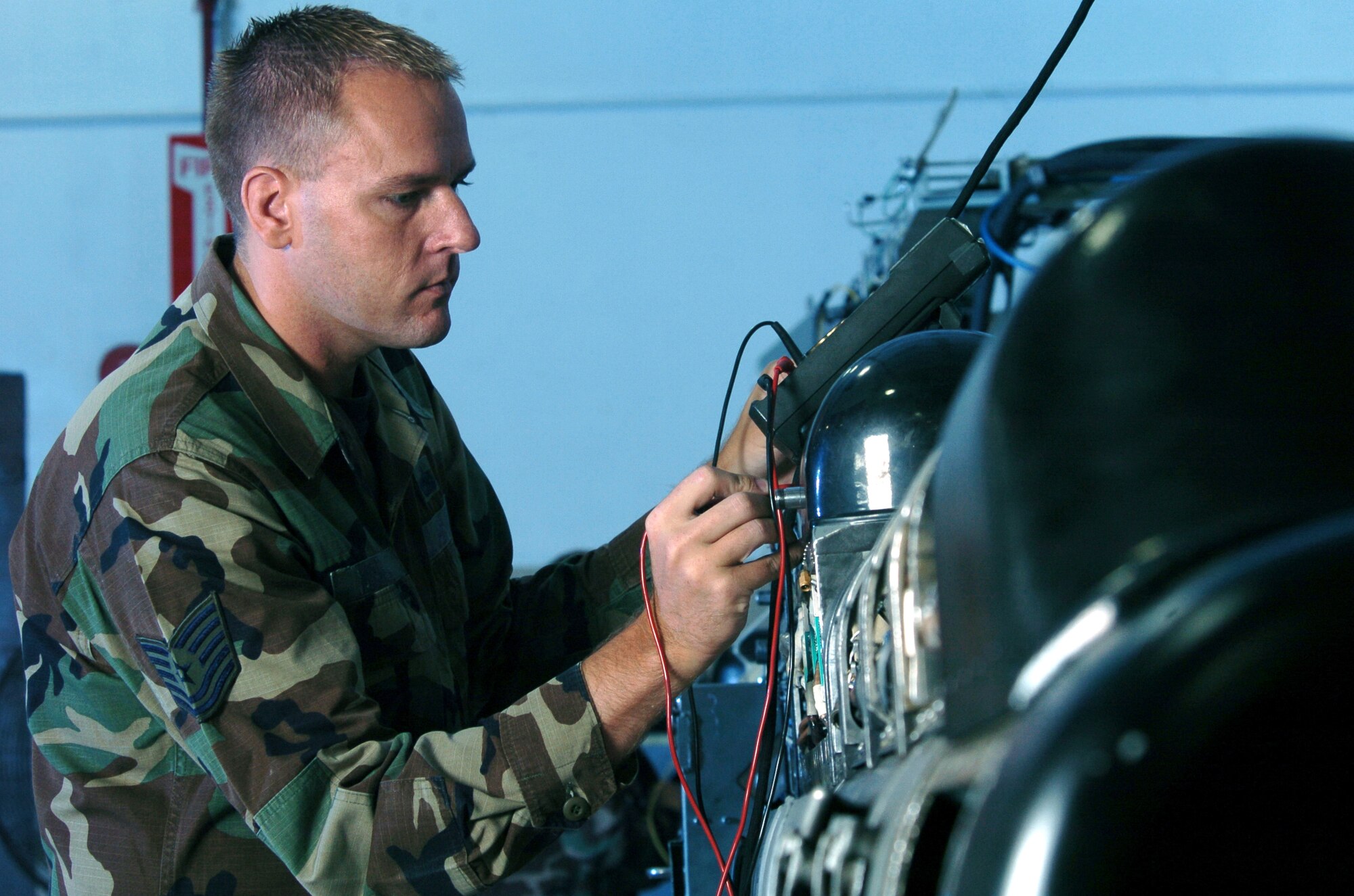 KUNSAN AIR BASE, South Korea -- Tech. Sgt. Brad Mikula uses a meter to check wires on the circuit card of an electronic countermeasures pod here.  The ECM technicians maintain the F-16 Fighting Falcons pods used to defeat sophisticated anti-aircraft defense systems.  Sergeant Mikula is assigned to the 8th Maintenance Squadron.  (U.S. Air Force photo by Master Sgt. Val Gempis)