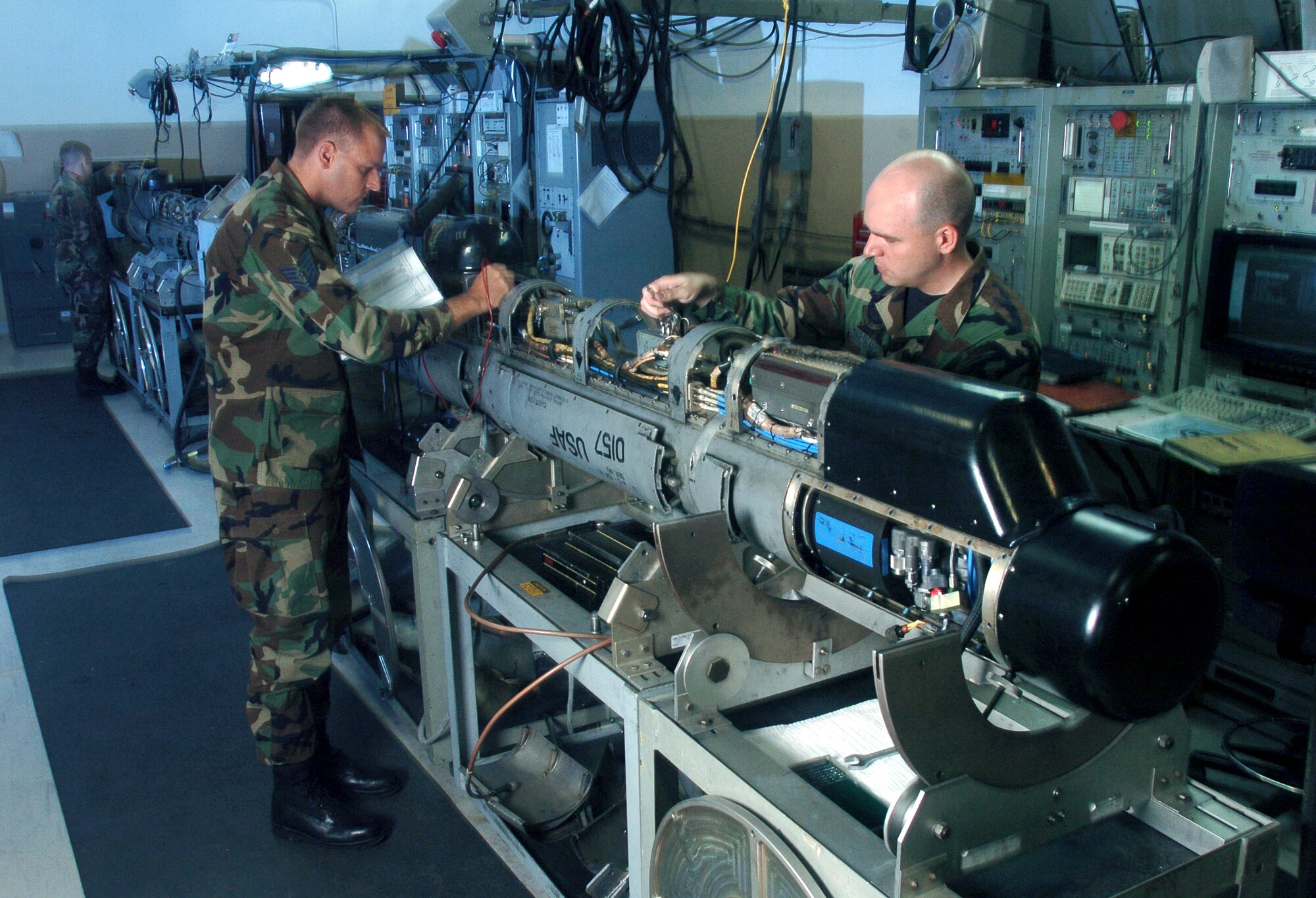 KUNSAN AIR BASE, South Korea -- Tech. Sgt. Brad Mikula (left) and Staff Sgt. Jesse Marshall inspect an electronic countermeasures pod here.  The ECM technicians maintain the F-16 Fighting Falcons pods used to defeat sophisticated anti-aircraft defense systems.  The Airmen are assigned to the 8th Maintenance Squadron.  (U.S. Air Force photo by Master Sgt. Val Gempis)