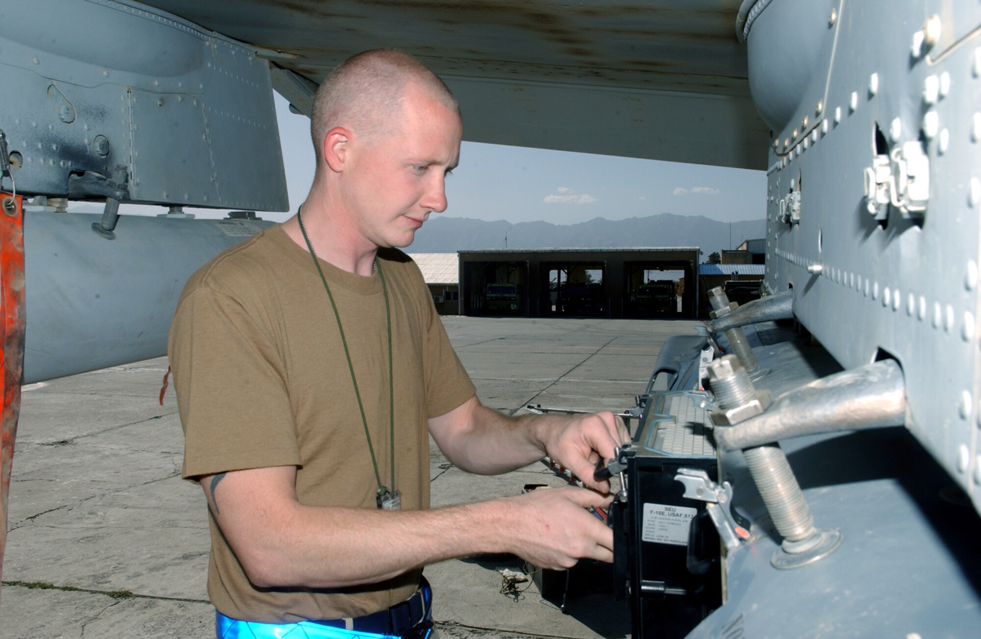 BAGRAM AIR BASE, Afghanistan -- Airman 1st Class Steven Brooks removes a part from an A-10 Thunderbolt II Laser Infrared Targeting and Navigation pod.  The part is one of six self-contained units on the pod which are sent to the manufacturer for service.  Airman Brooks is assigned to the 354th Expeditionary Aircraft Maintenance Squadron here.  (U.S. Air Force photo by Master Sgt. Andrew Gates)