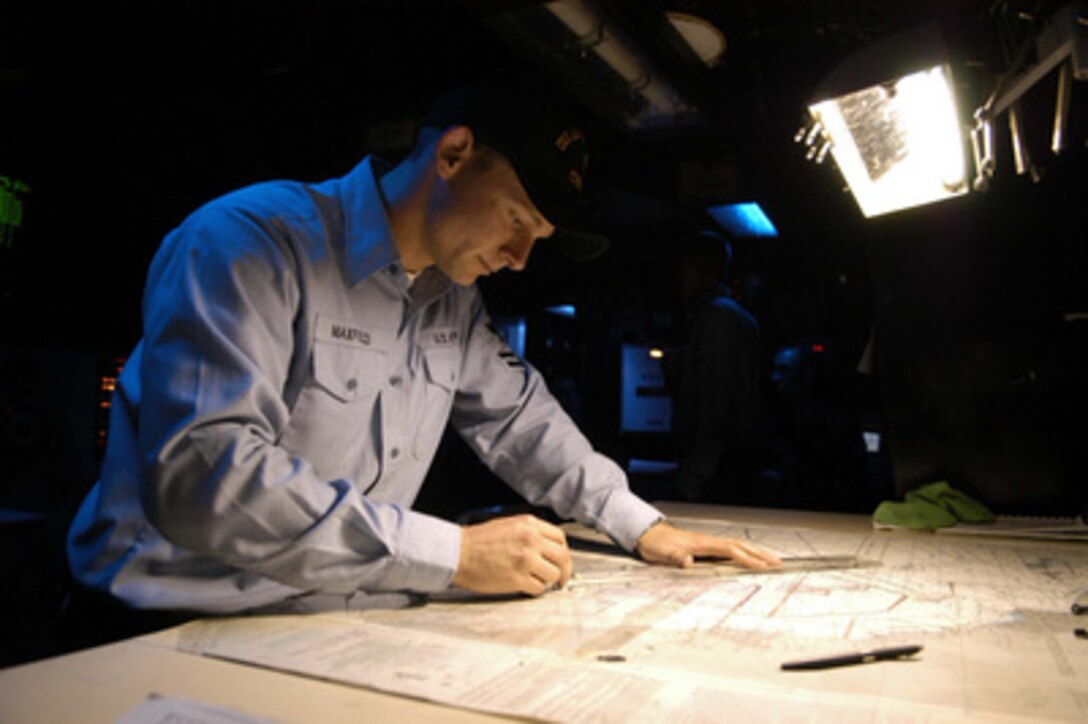 Navy Petty Officer 2nd class Ryan E. Maxfield plots the ship's position on a navigational chart aboard the aircraft carrier USS Abraham Lincoln (CVN 72) on Aug. 18, 2004. The Lincoln is currently conducting operations in preparation for an upcoming deployment. Ryan is a Navy operations specialist. 