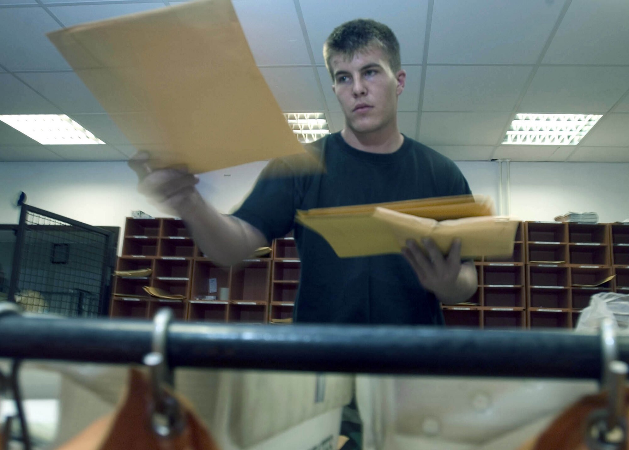 RAMSTEIN AIR BASE, Germany -- Airman 1st Class Clayton Hobbs sorts through the morning mail at the 86th Communication Squadron's official mail center here.  He is a postal clerk at the largest official mail center outside of the continental United States.  (U.S. Air Force photo by Master Sgt. John E. Lasky)