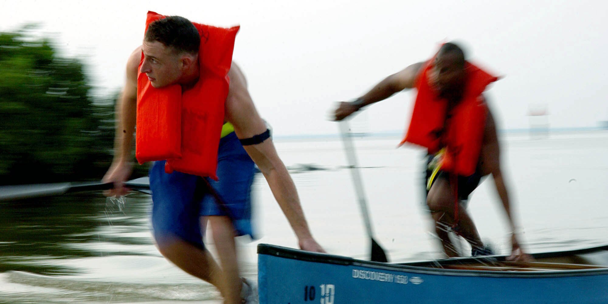 MACDILL AIR FORCE BASE, Fla. -- Senior Airman Thomas Keefe and 1st Lt. Dave Gray beach their canoe during the Aug. 21 Enduro Challenge here.  Next, the team had to carry their canoe roughly a quarter mile down a sandy beach before starting the next portion of the race.  (U.S. Air Force photo by Staff Sgt. Randy Redman)