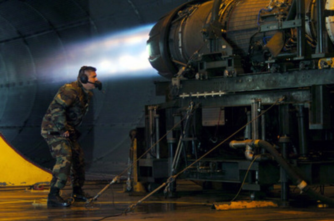 Air Force Staff Sgt. Daniel Guerra looks for fuel leaks in an F-16 fighter engine running at full afterburner in the test cell facility at Osan Air Base, Korea, on Aug. 23, 2004. Guerra is an engine propulsion mechanic with the 51st Maintenance Squadron at Osan. 